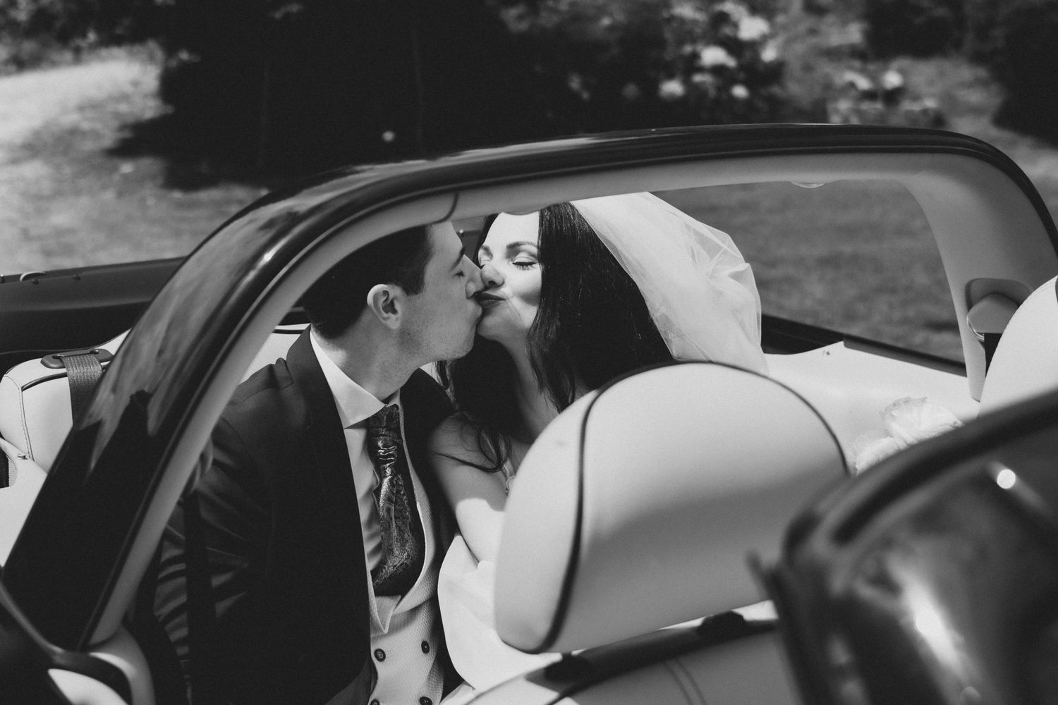 A black and white photo sequence showing a person getting into a car through the driver's side door.