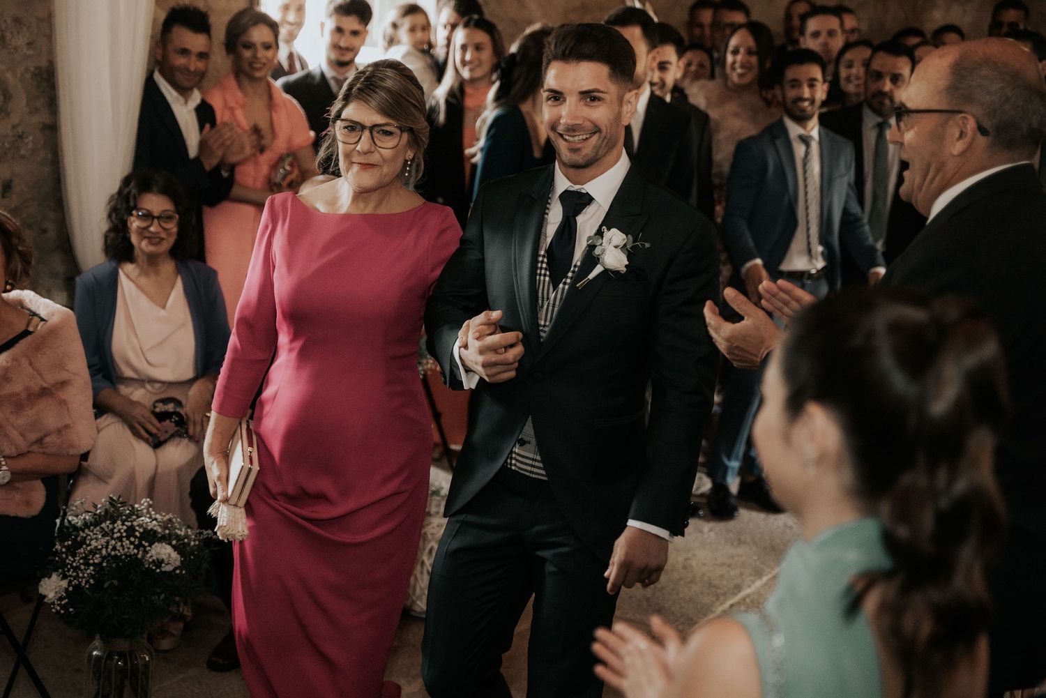 Wedding guests dance and celebrate together on the dance floor during a joyous reception celebration.