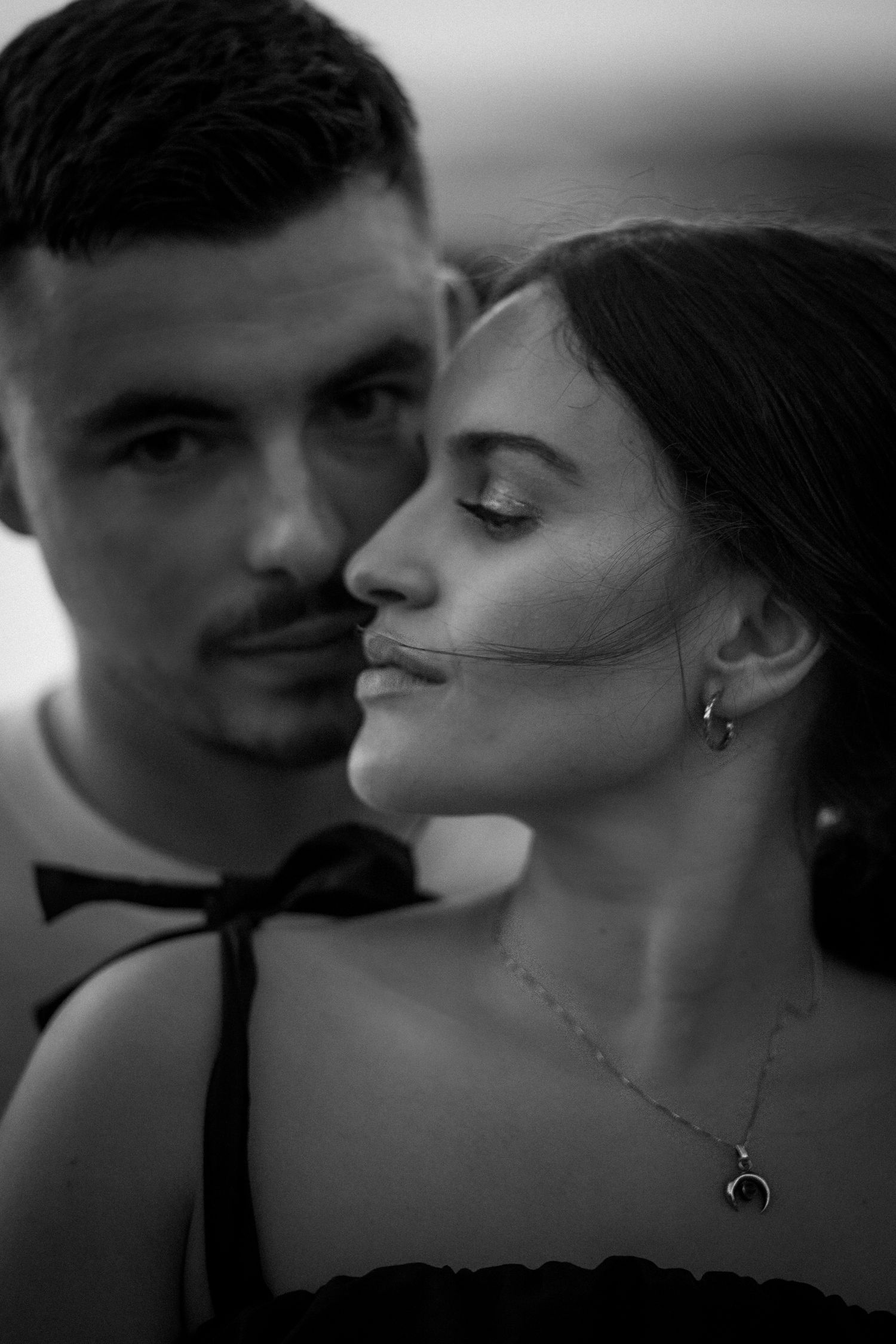 A series of black and white romantic photographs showing a couple in intimate kissing poses.