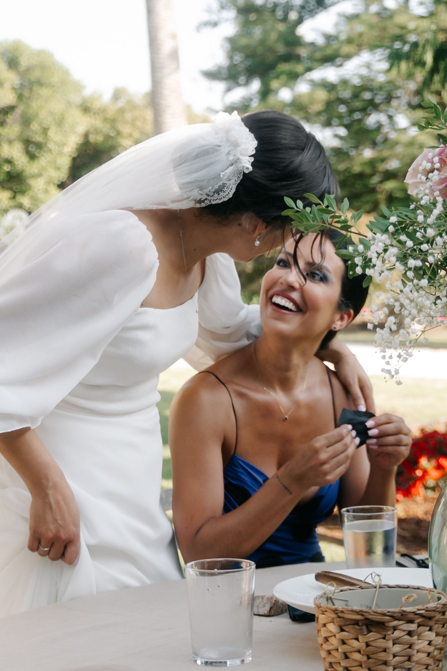 A candid sequence of five photos showing joyful laughter during a wedding celebration at an outdoor venue.