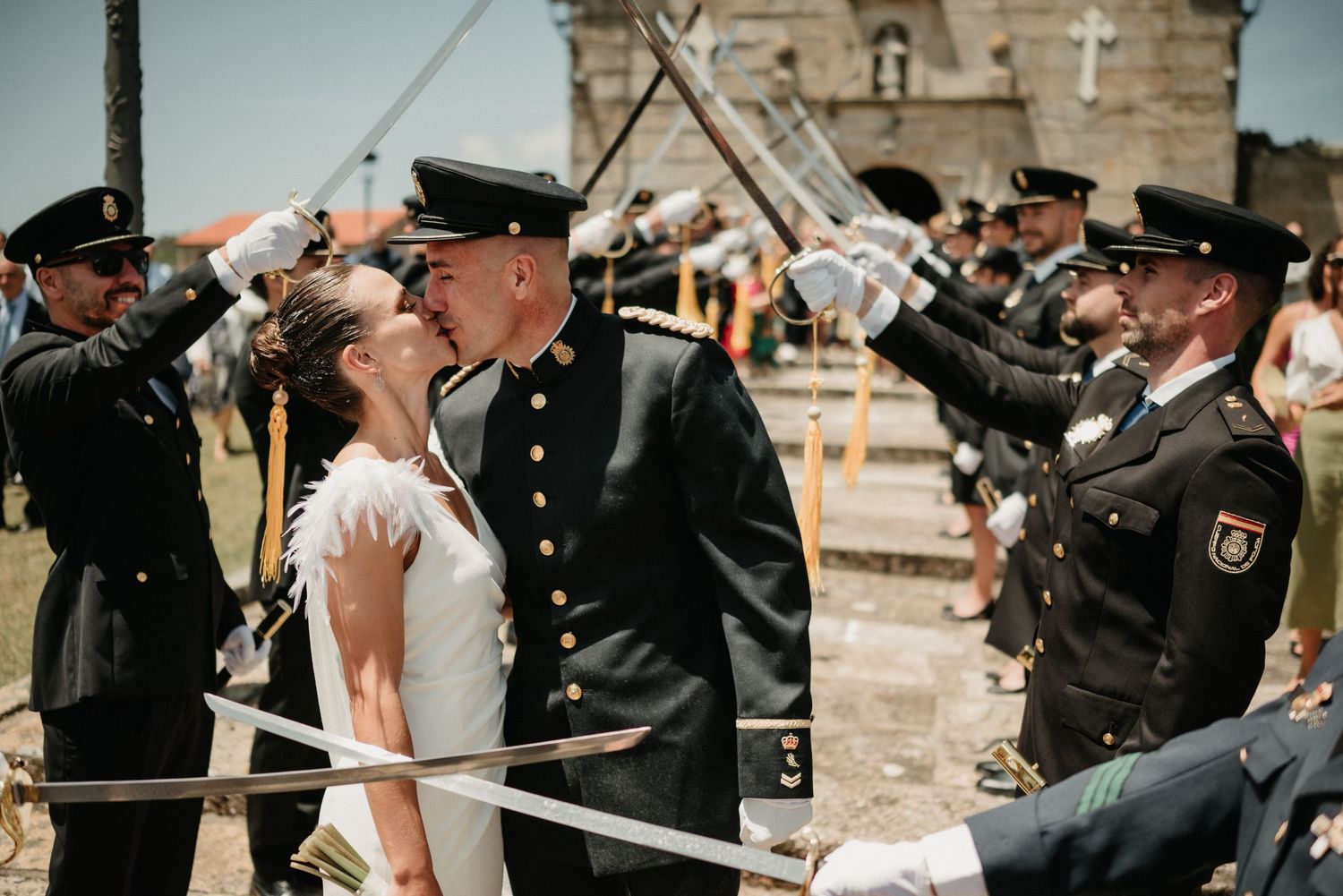 Military honor guard forms sword arch for newlyweds at traditional military wedding ceremony.