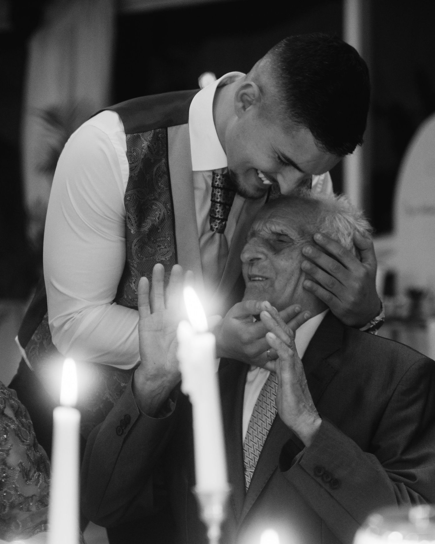 A series of black and white candid photos showing emotional moments between two people during what appears to be a wedding.