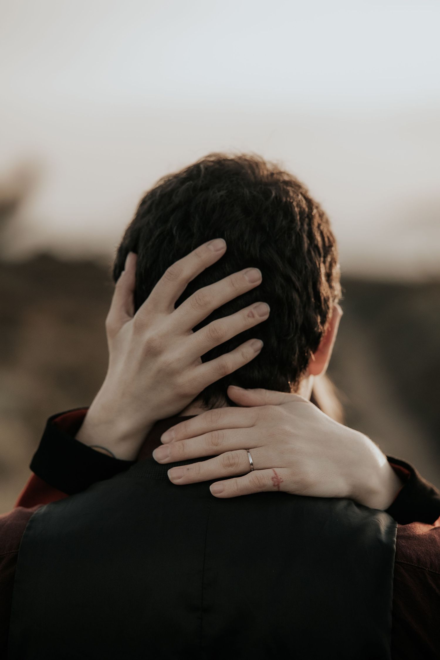 Close-up shots showing hands tenderly caressing the back of a person's head in sequence.