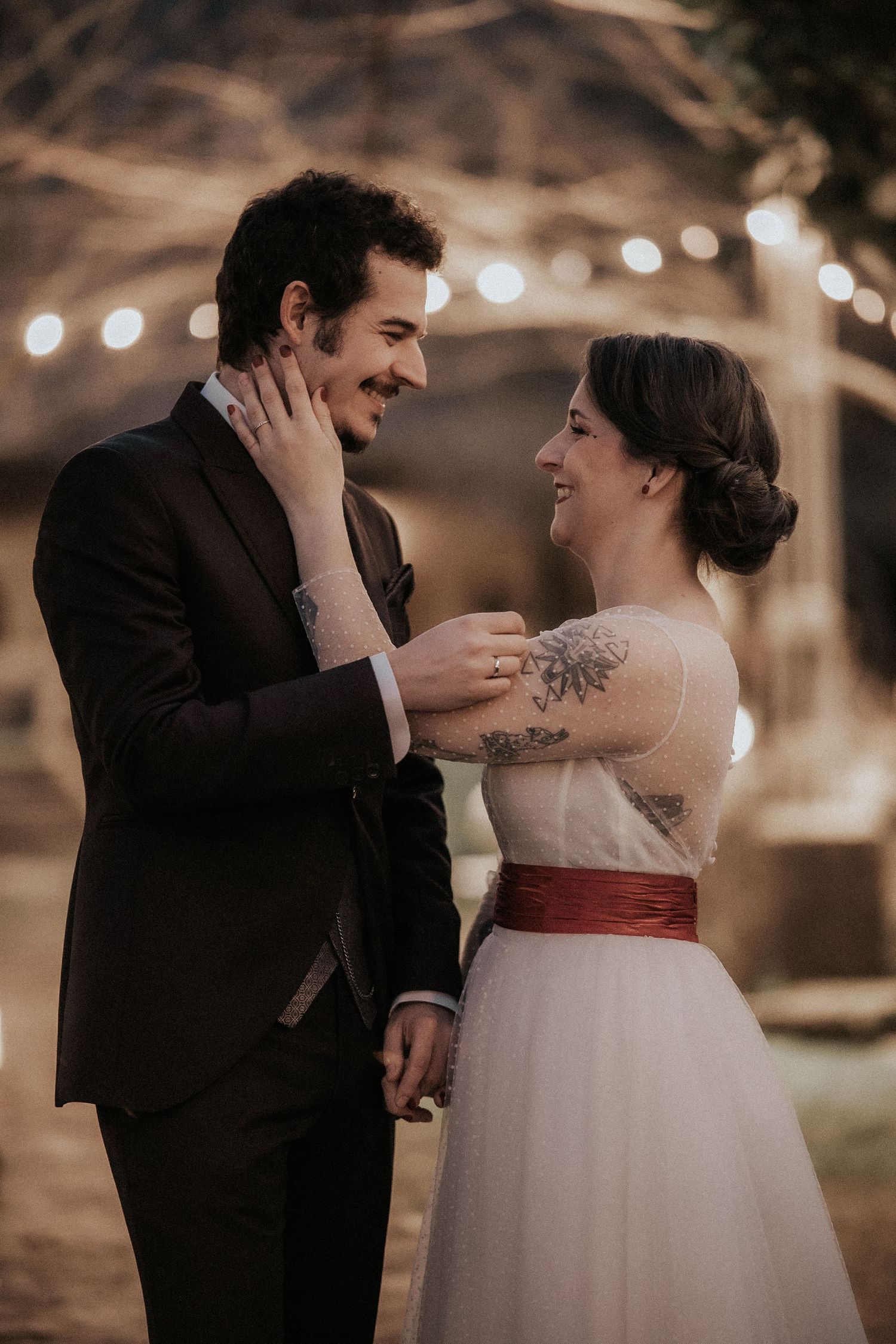 A romantic wedding photo series showing a couple in white dress and black suit sharing tender moments at dusk.