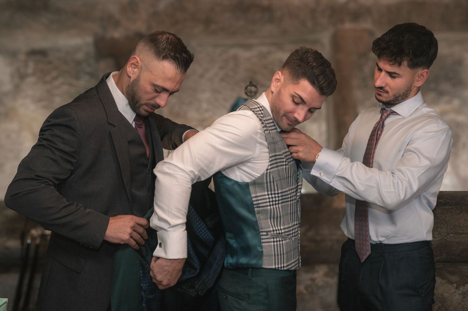 Group of people sharing laughter and emotional moments in formal attire.