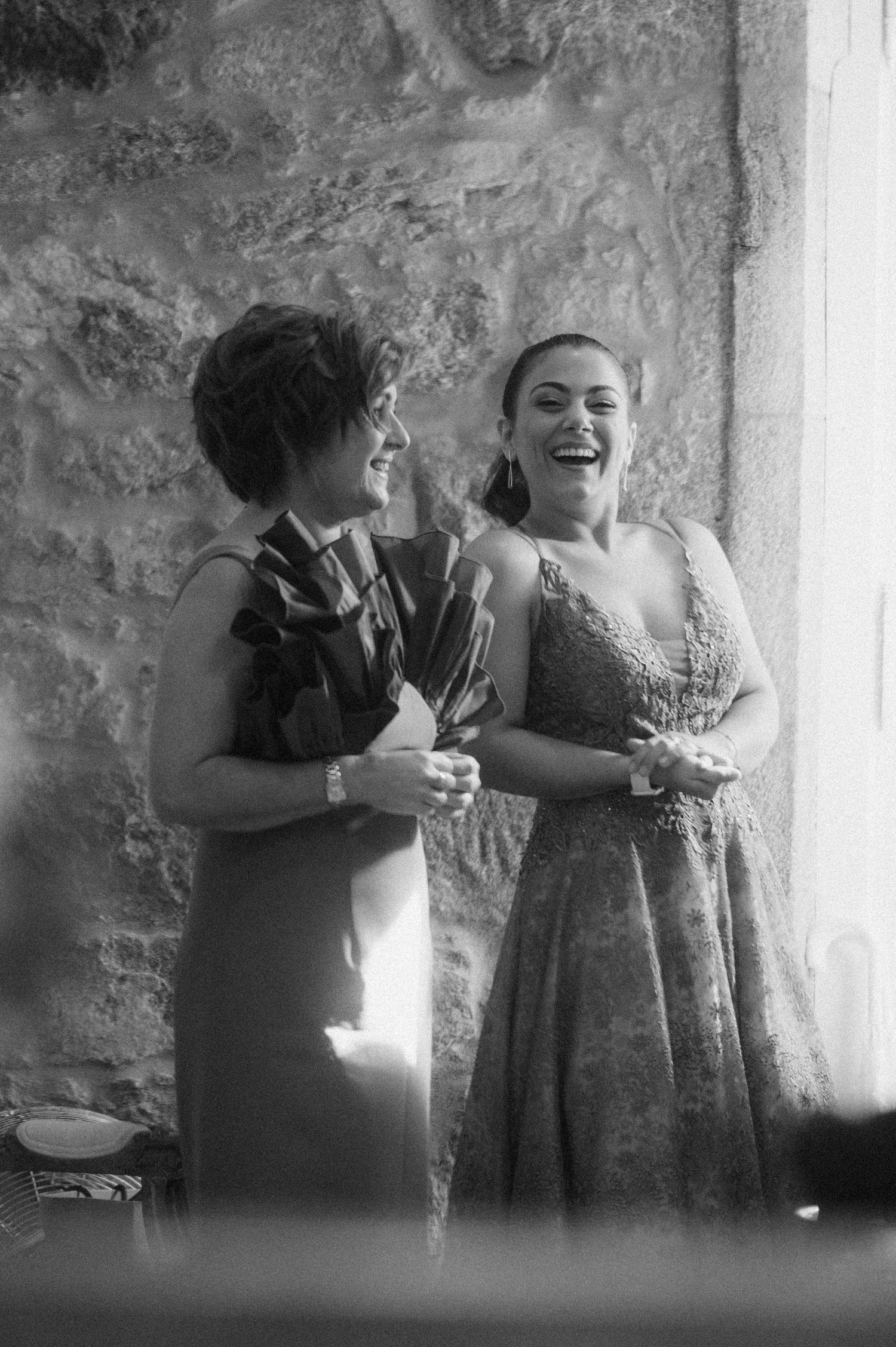 Two people laughing and dancing together in a black and white photo series.
