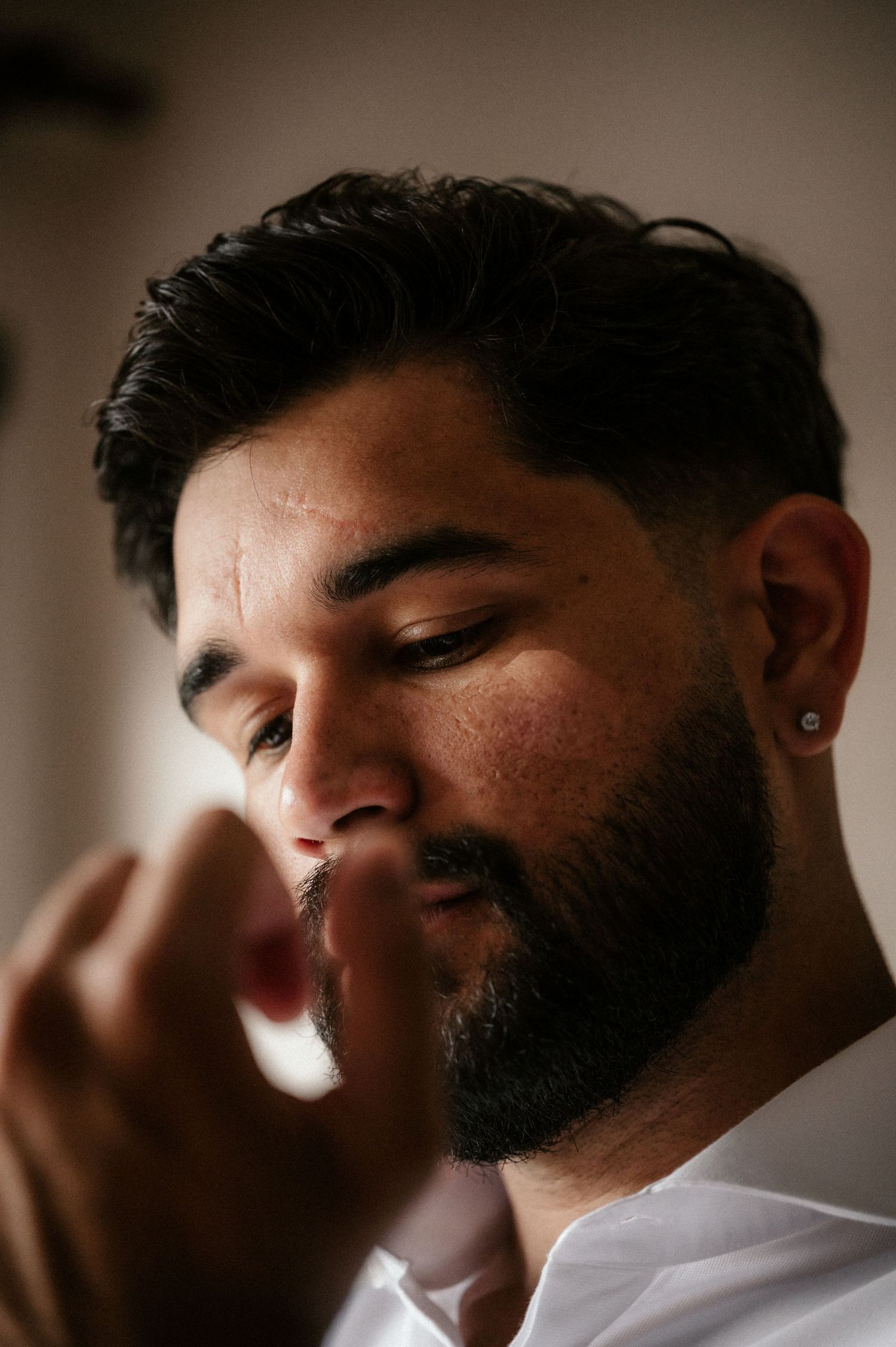 Artistic series of profile shots showing a bearded person in dramatic lighting and shallow depth of field.