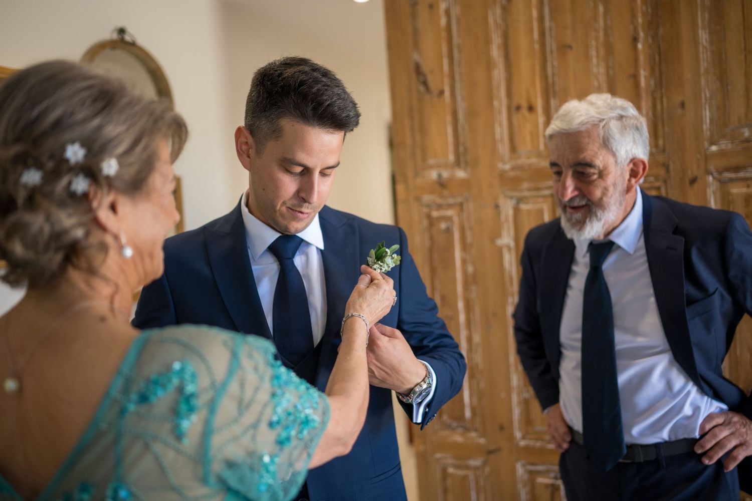 Wedding guests share emotional moments during a reception celebration in a rustic wooden venue.