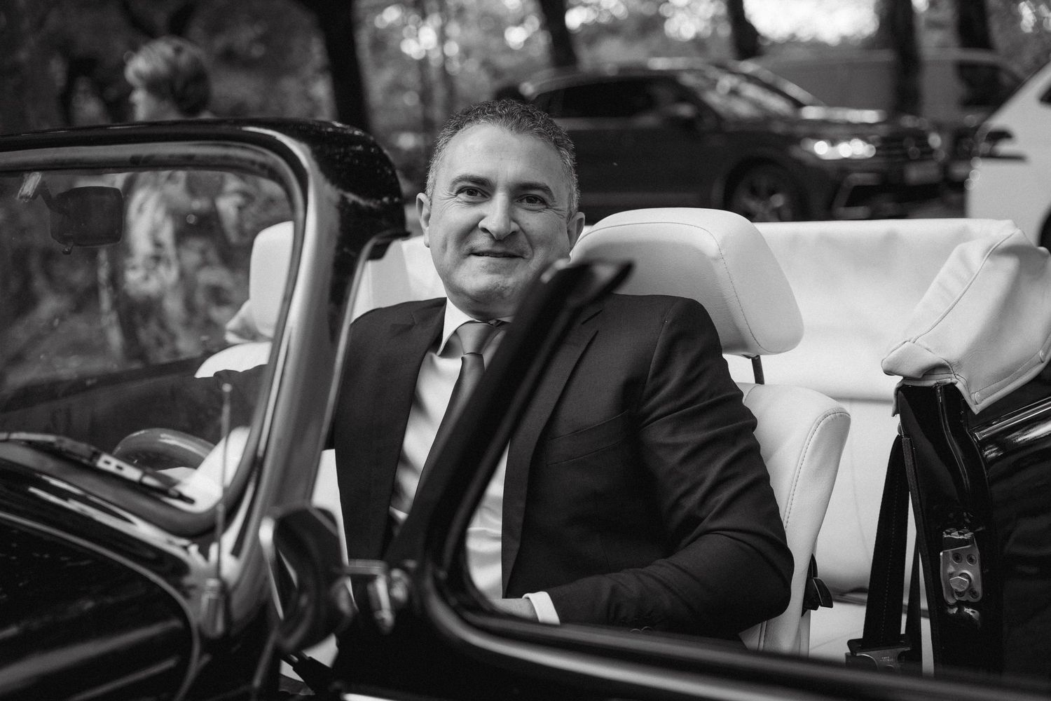 A series of black and white wedding photos showing couples in cars and romantic moments.