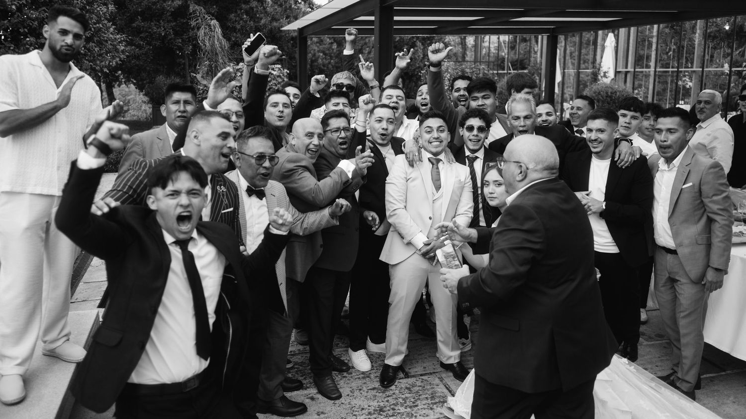 A black and white panoramic collage shows people dancing and celebrating at what appears to be a wedding reception.