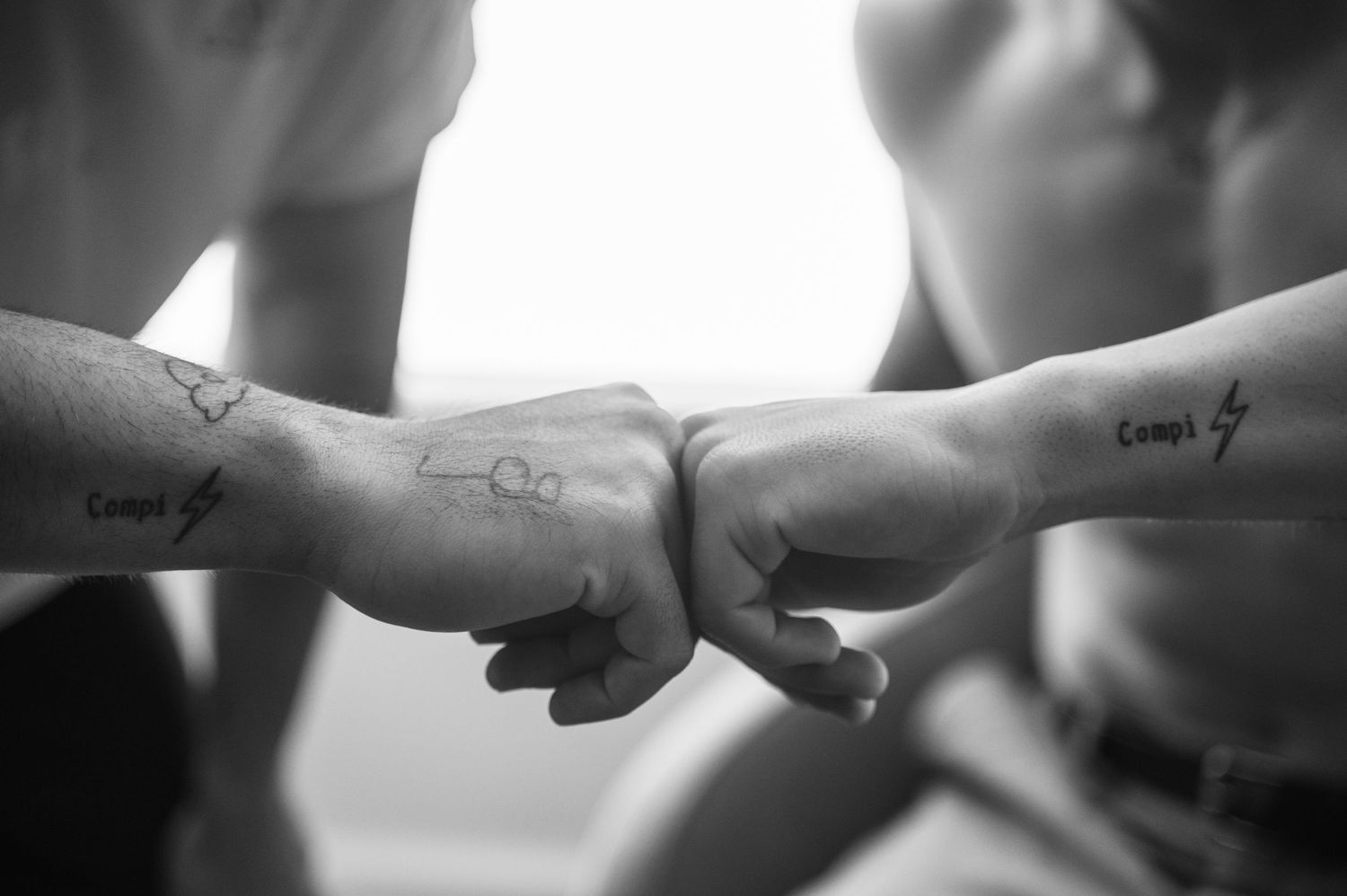 A series of black and white photographs showing close-up shots of hands and arms in various positions and gestures.