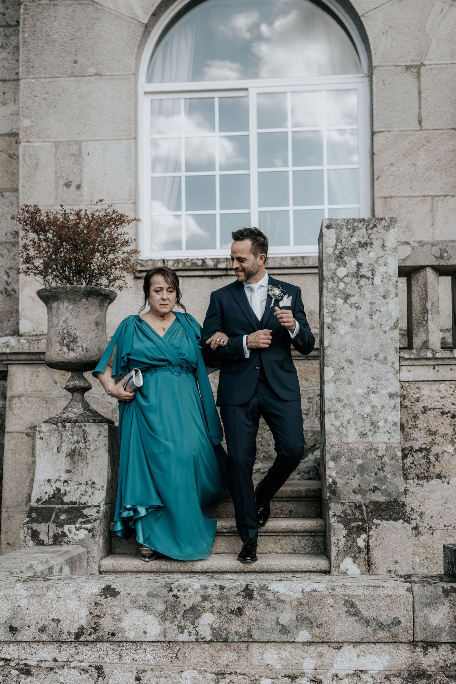 Couple sitting on stone ledge at historic building with arched window and weathered walls in triptych sequence.