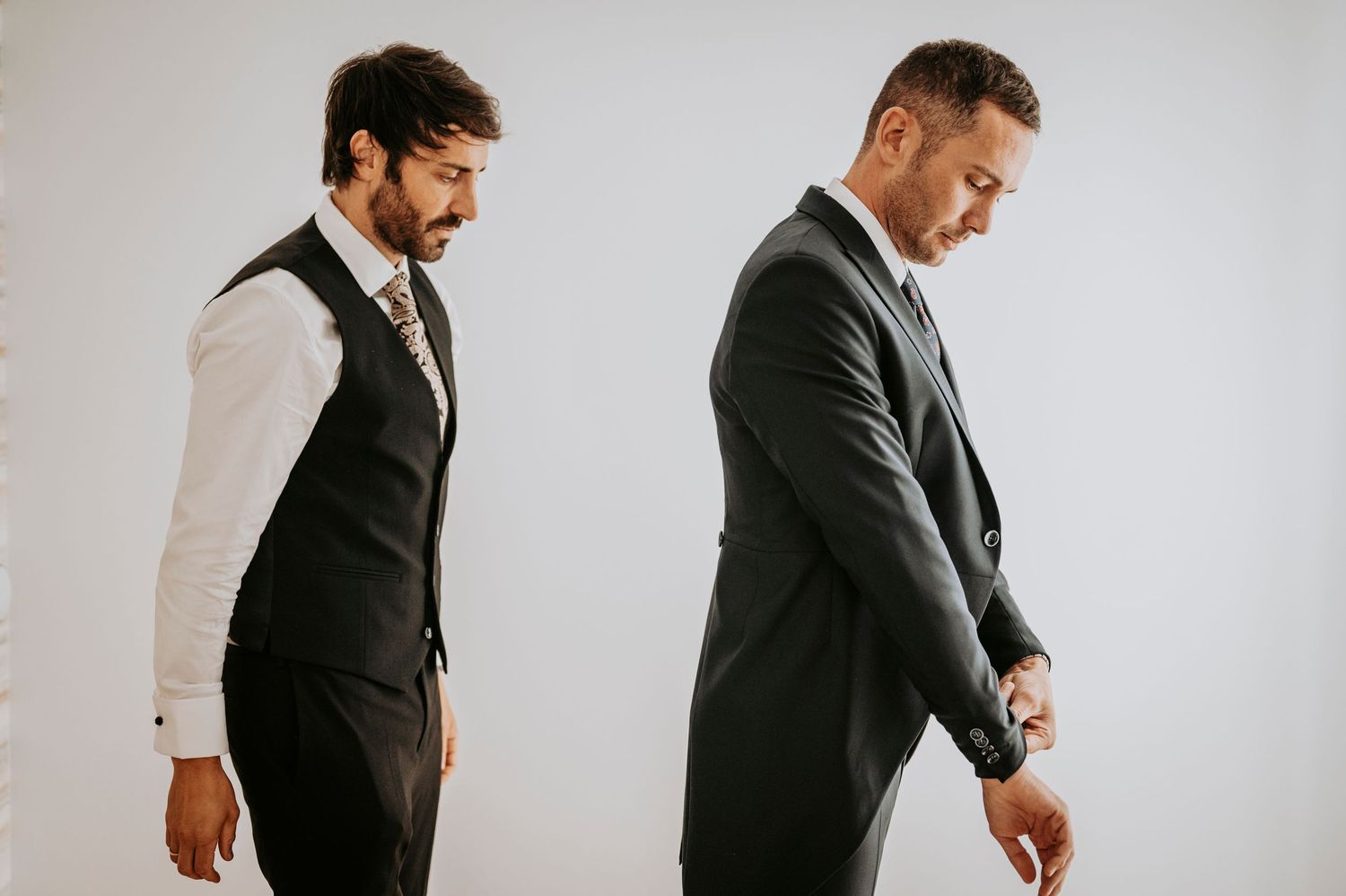 Professional groom getting ready for wedding ceremony in classic black suit and vest.