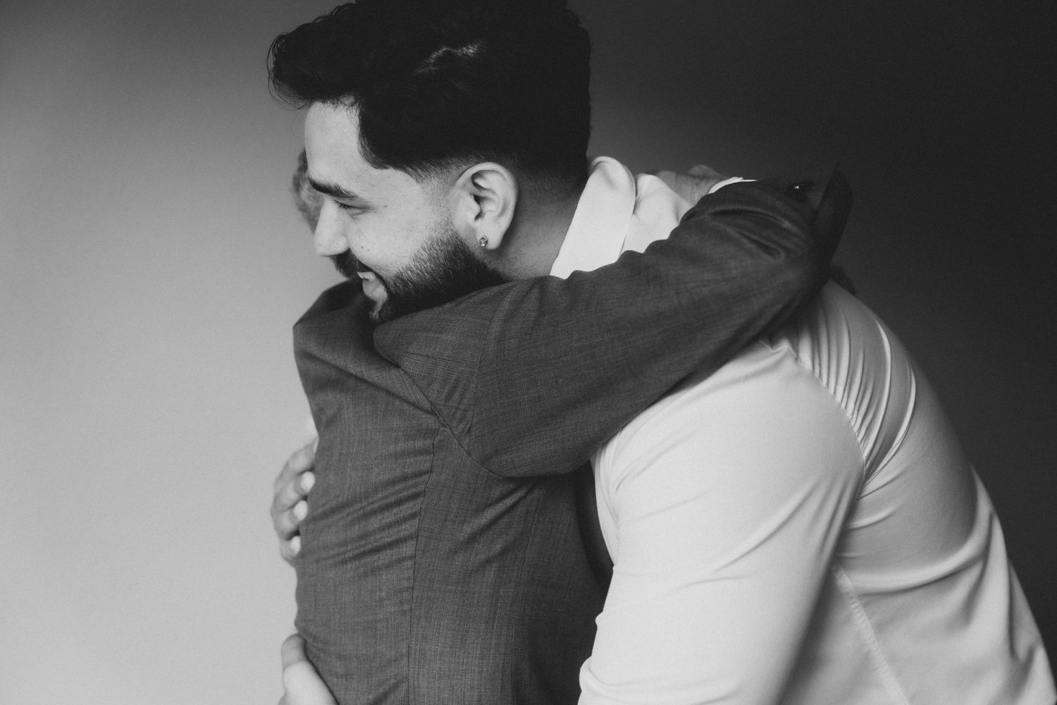 Black and white image sequence showing a couple in an intimate embrace with dramatic lighting and shadows.