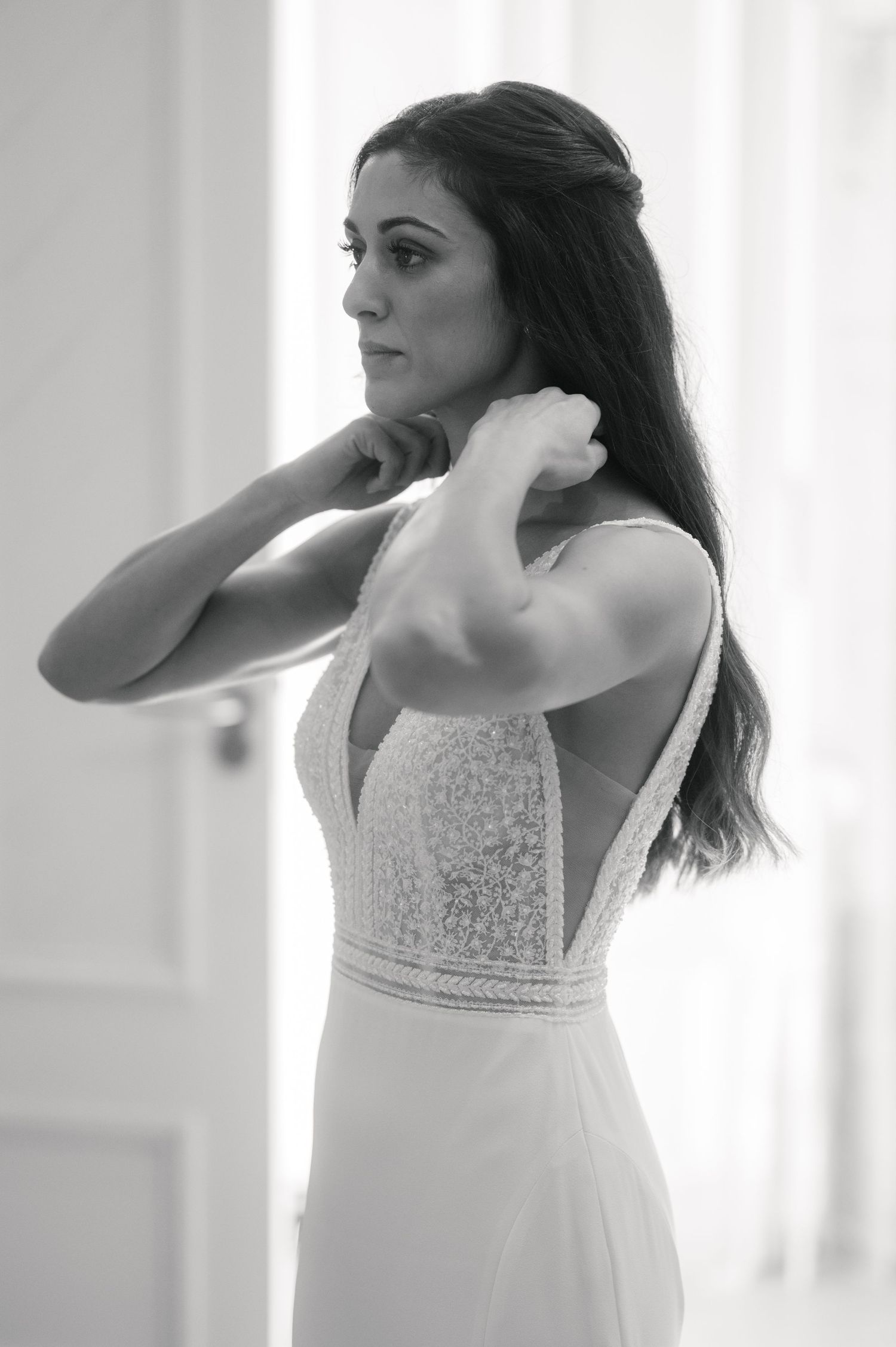 Candid black and white photo series showing movement in an elegant white dress.