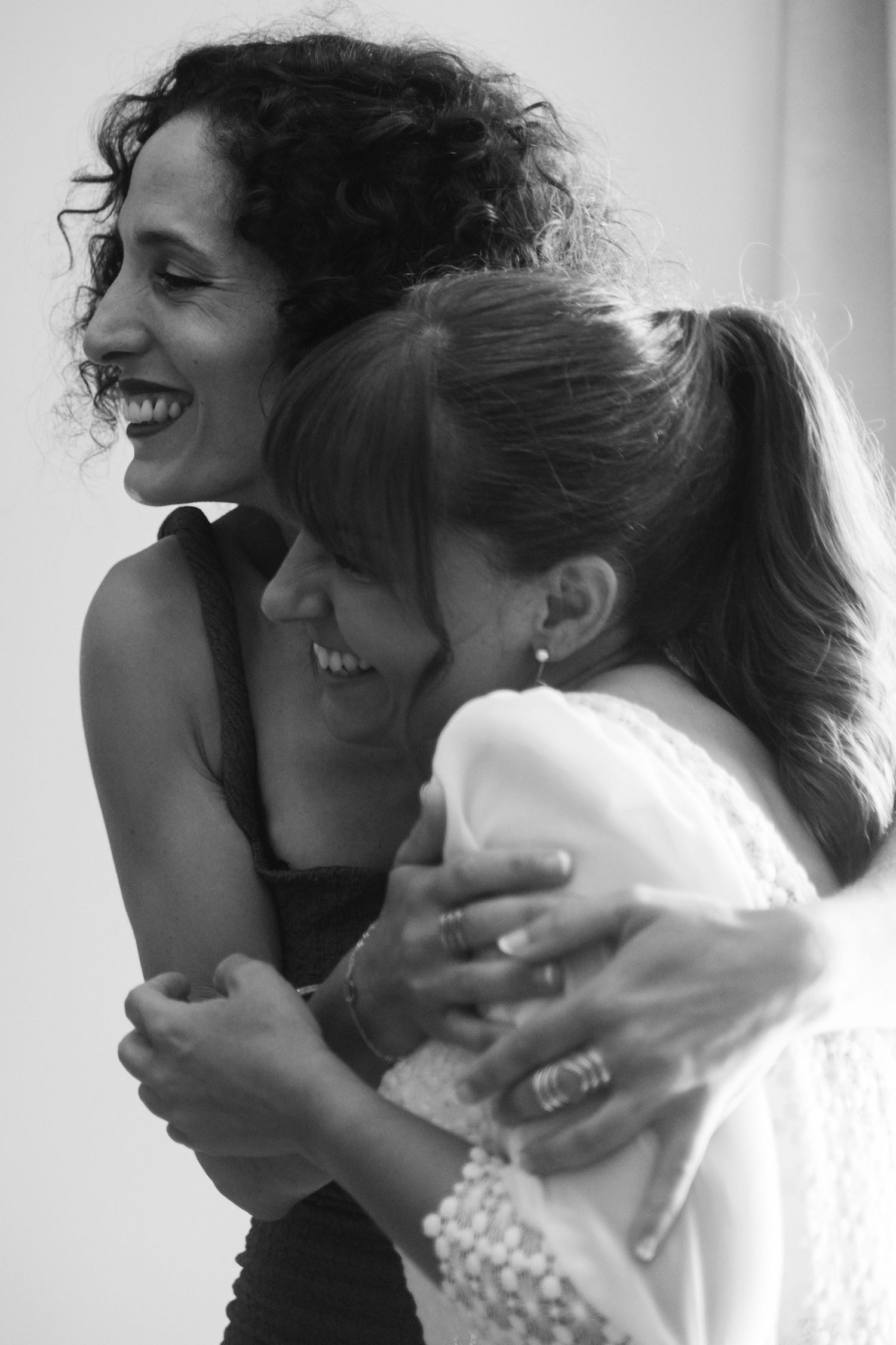 Black and white photo of two people embracing in an emotional moment.