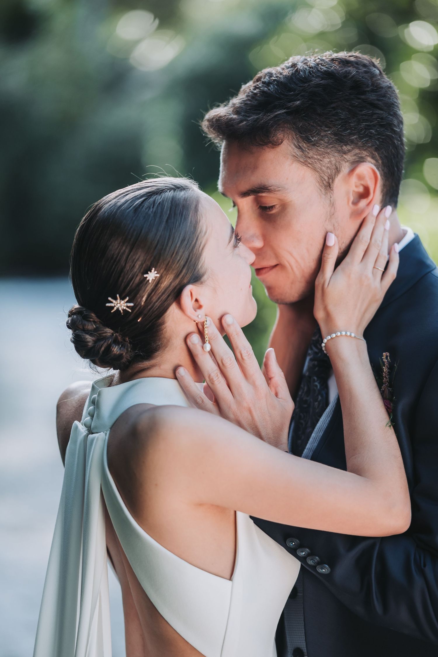 Multiple frames capture an intimate first kiss moment between newlyweds against a soft bokeh background.