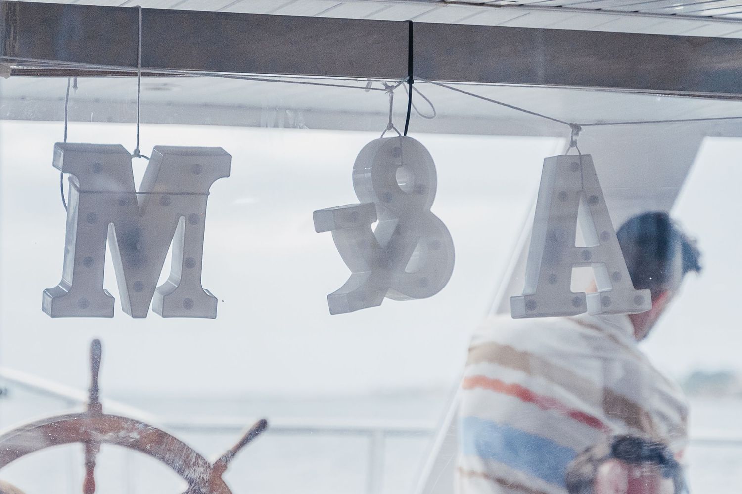 A blurry, abstract view of a retail store interior with white signage and shelving visible in the background.
