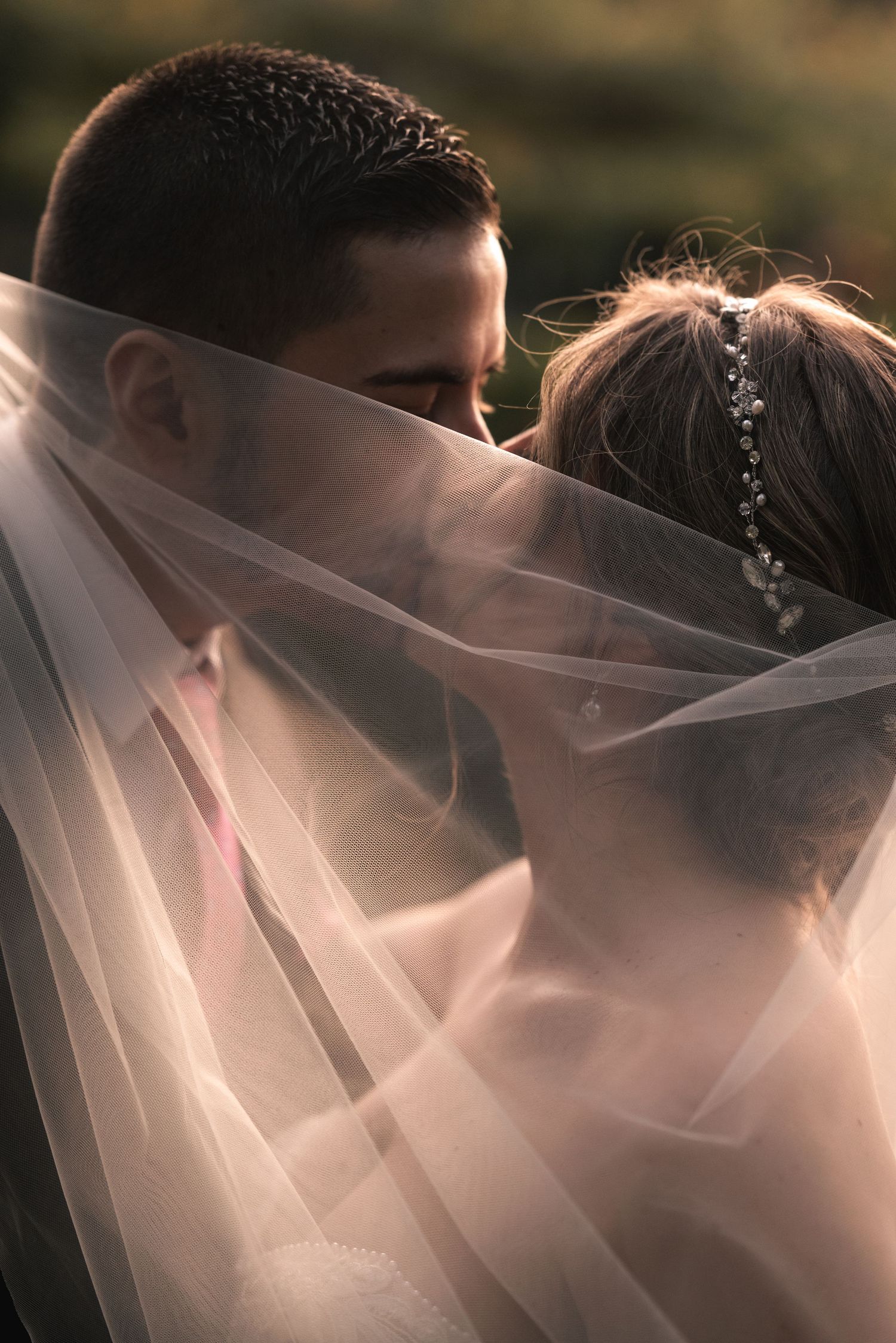 Ethereal wedding veil captures delicate silhouettes against soft natural light.