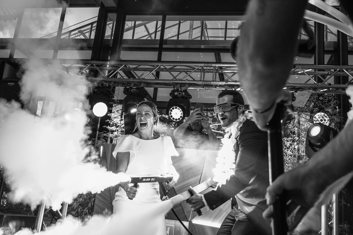 Concert stage filled with atmospheric fog and dramatic lighting effects during live performance.