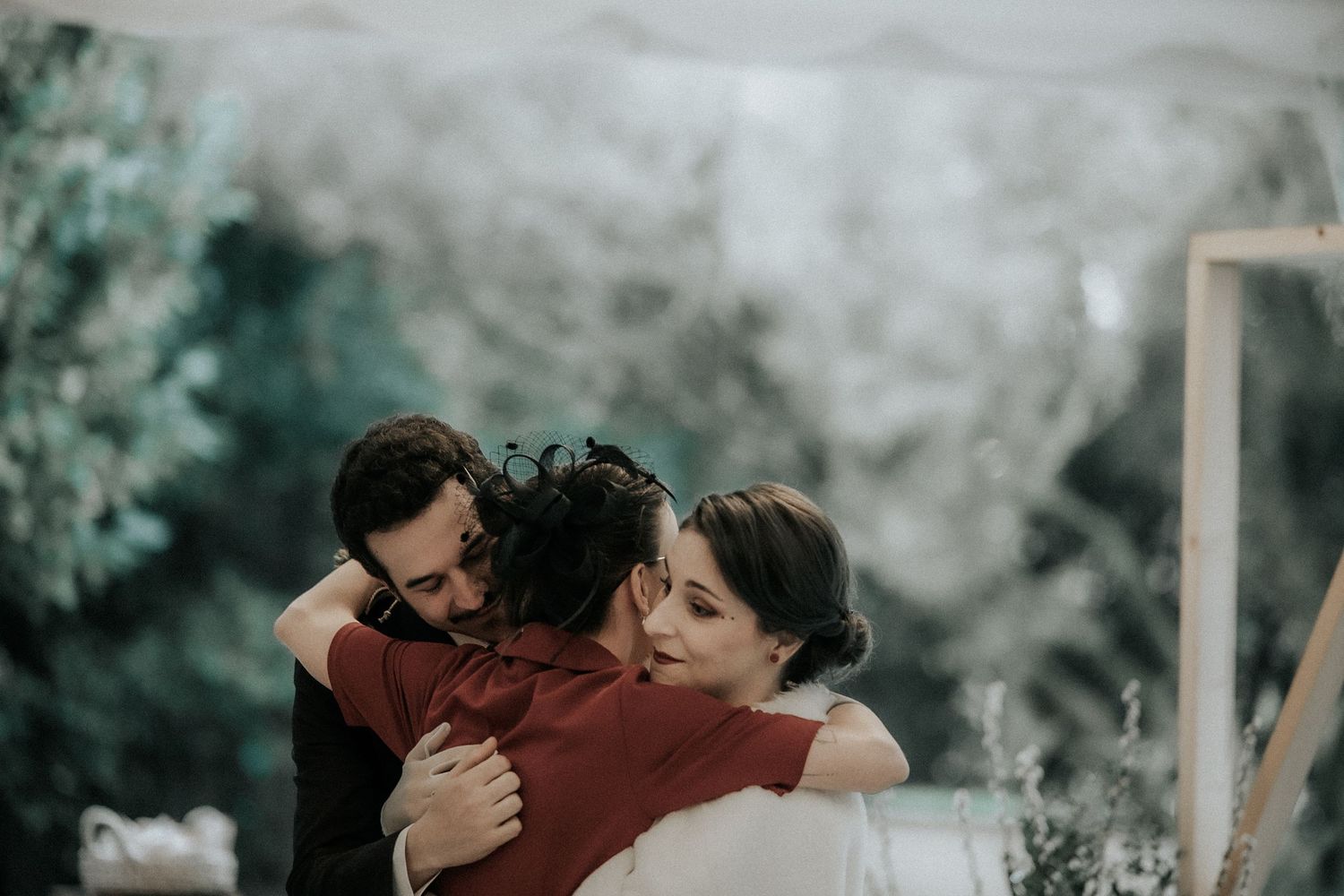 A romantic wedding moment captured in a misty outdoor setting with dramatic lighting.