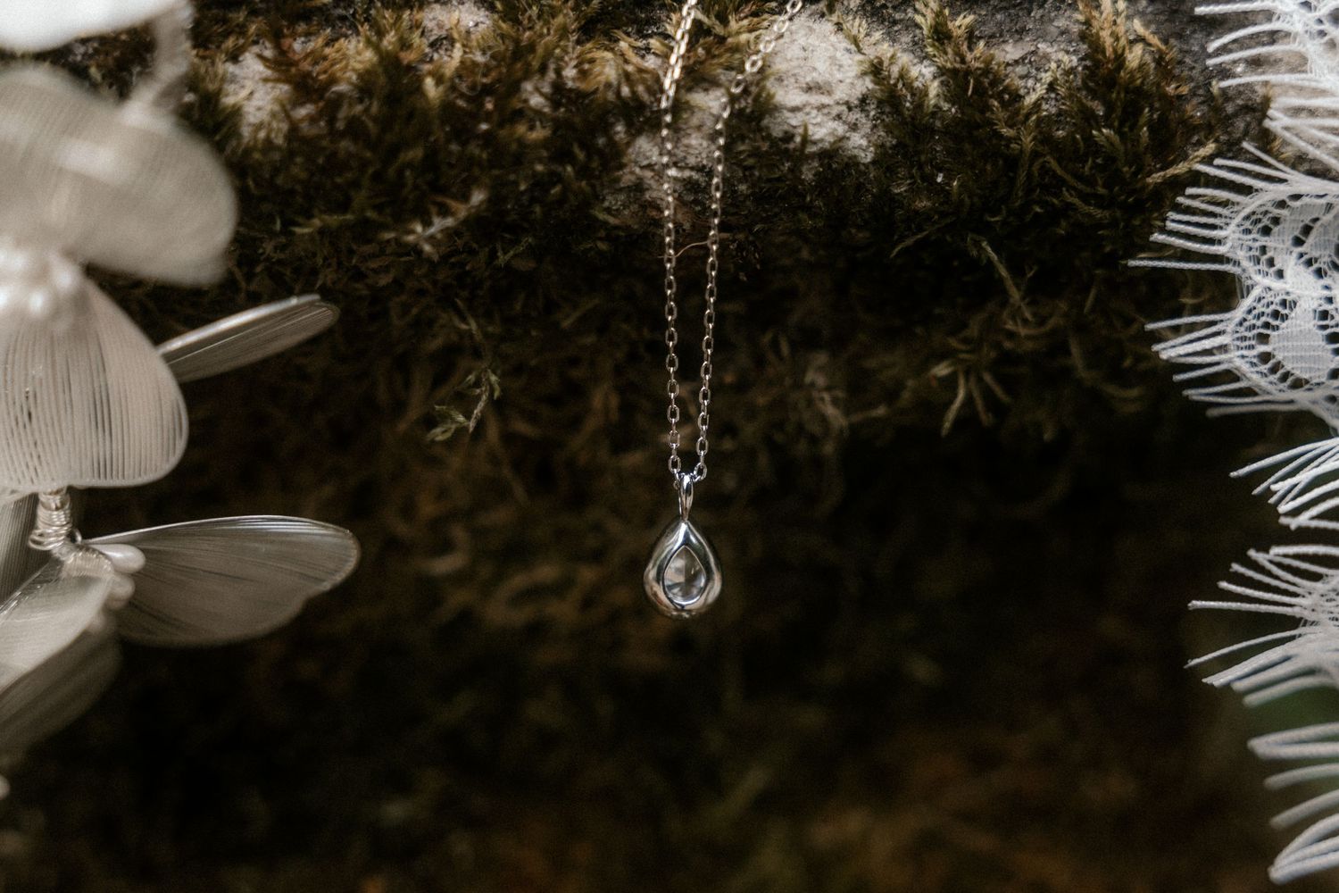 Close-up view of crystal ornaments and white branches on an elegant Christmas tree with soft bokeh lighting.
