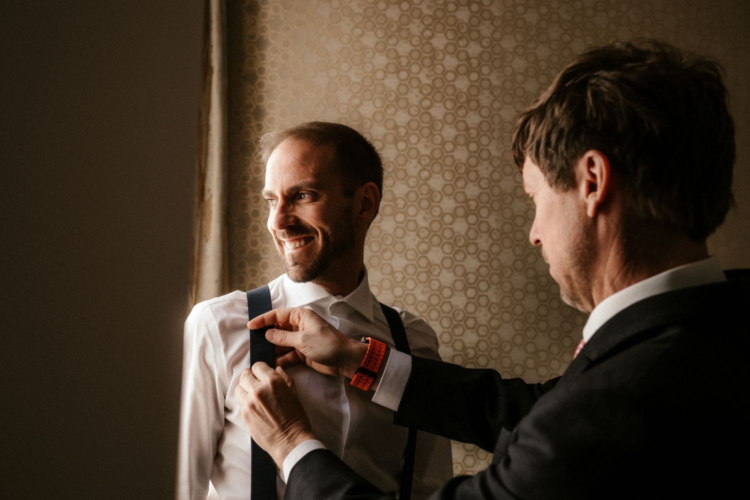 A series of candid black and white photos showing people laughing and interacting at a formal event.