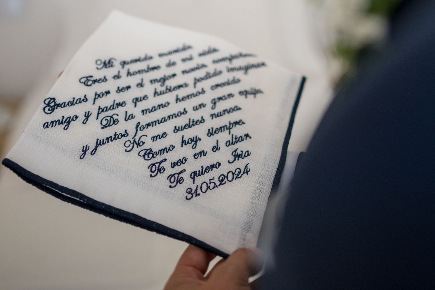 Close-up view of handwritten text on white paper being written with a fountain pen.