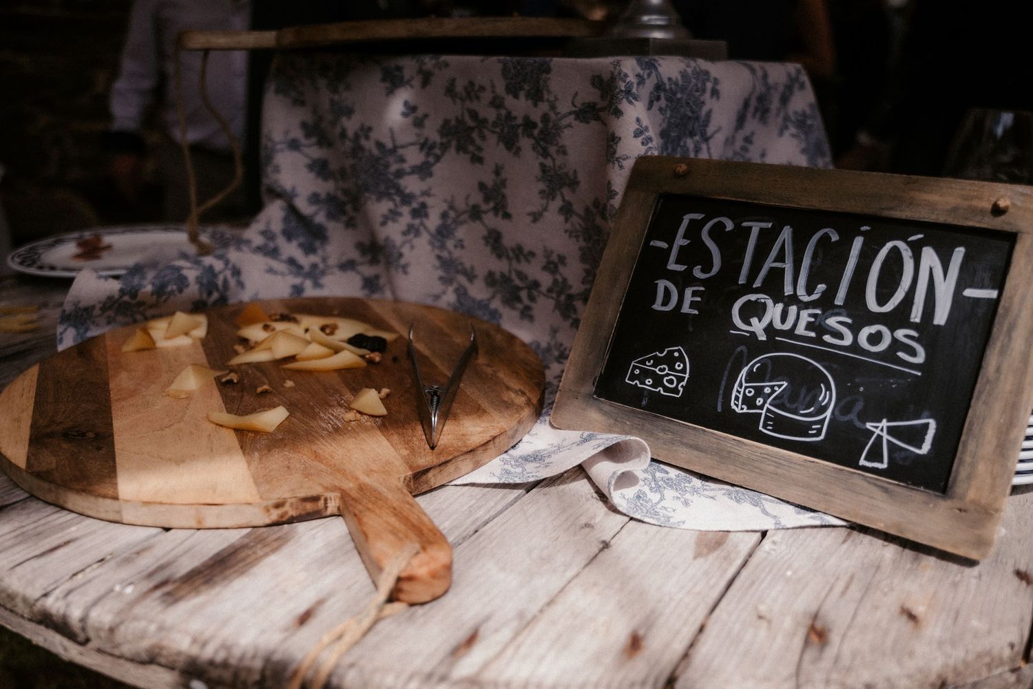 Wedding reception dessert table with rustic wooden signs and decorations.