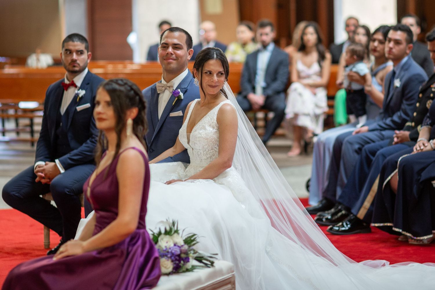 A bride and groom share an intimate moment during their Catholic church wedding ceremony.