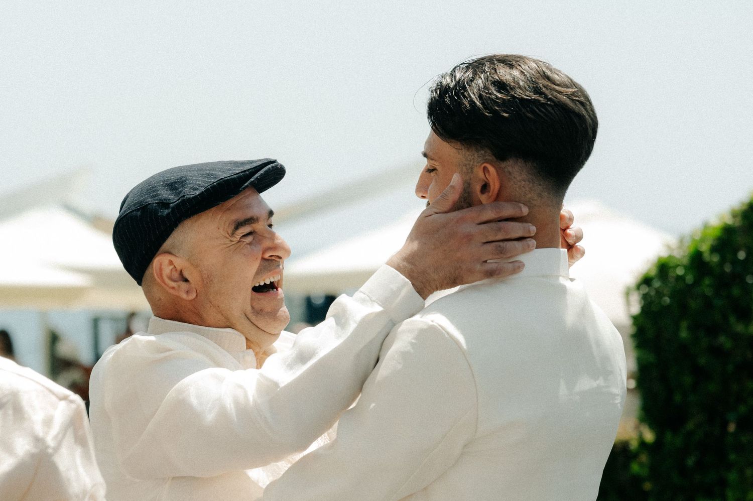 Two people share an emotional embrace during a special moment at an outdoor gathering.