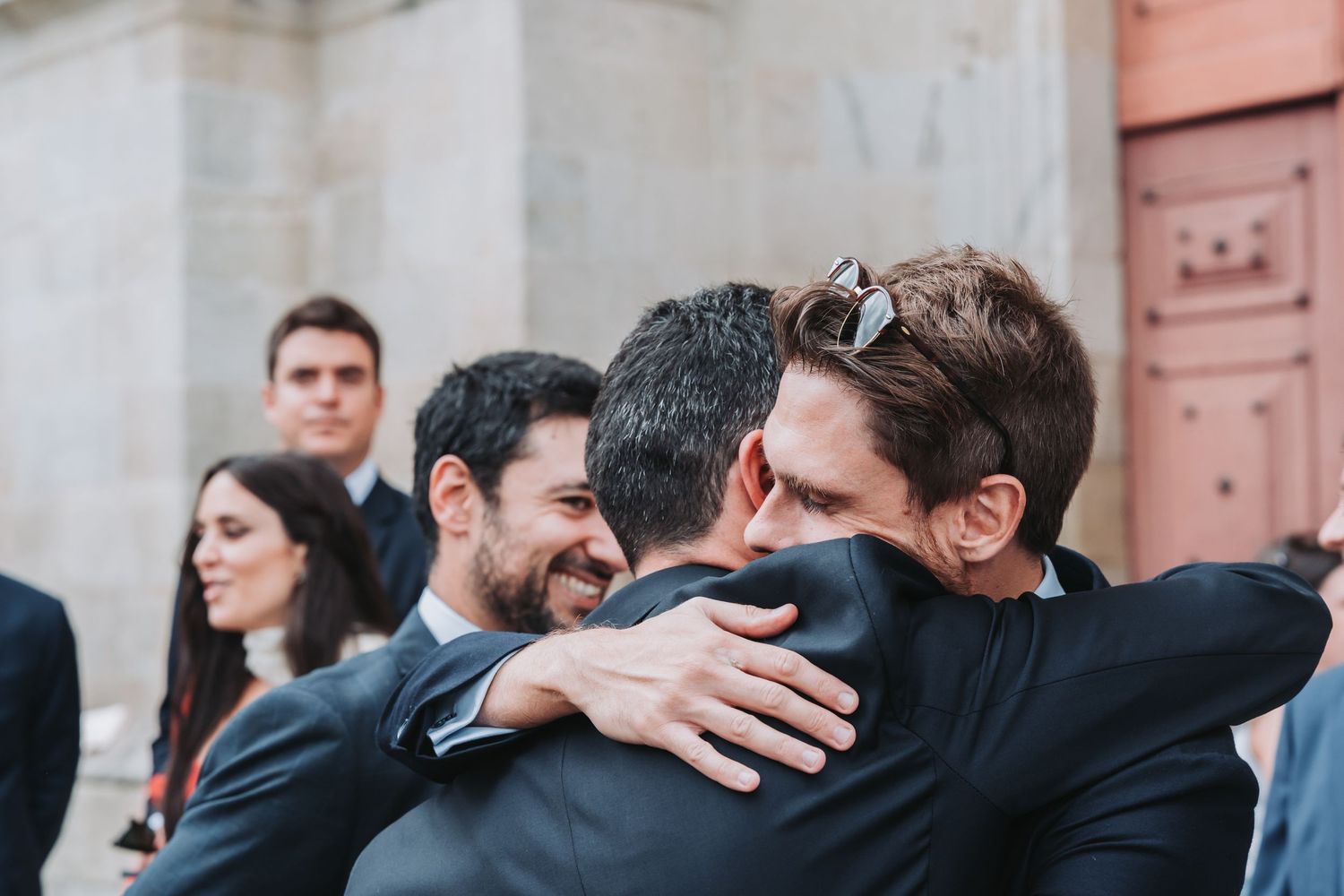 A sequence of photos showing two people embracing in an emotional moment outside a building.