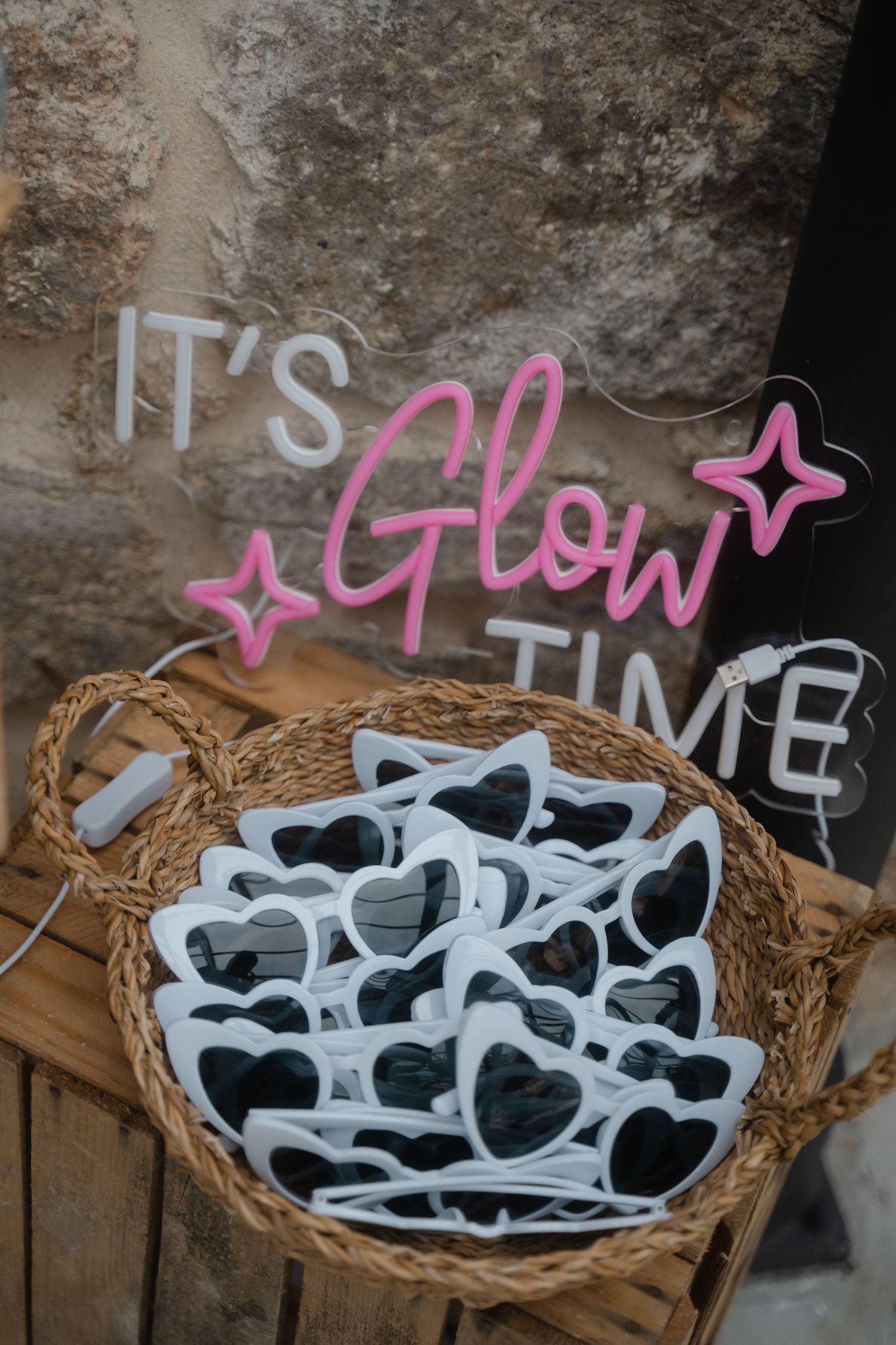 White sunglasses arranged in a woven basket with 'IT'S TIME' text visible.