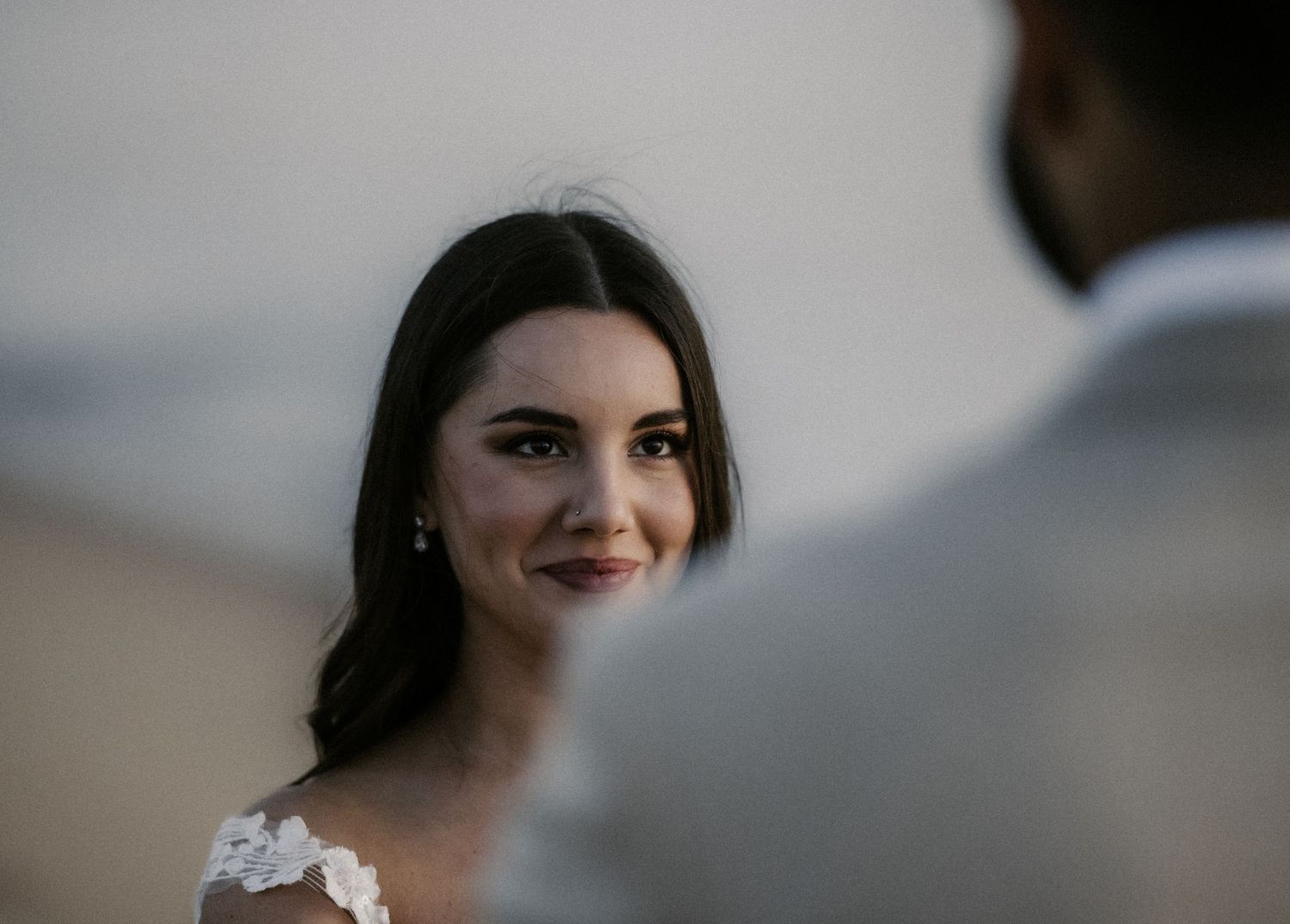 A series of intimate wedding portraits showing tender moments and smiles in soft lighting.