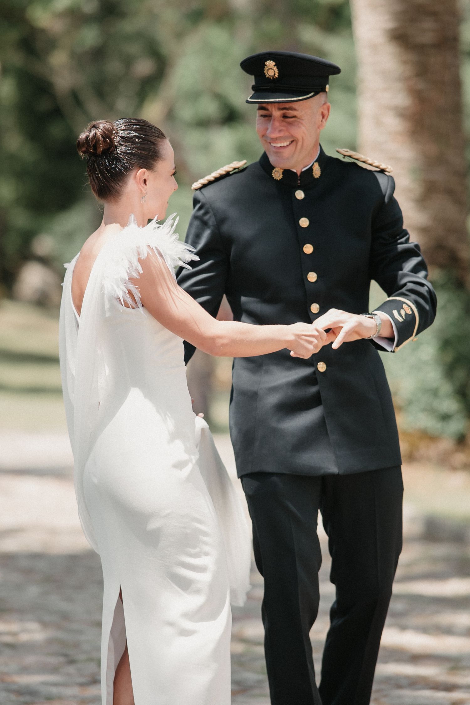 A couple shares their first look moment as the bride in white meets her groom in military dress uniform.