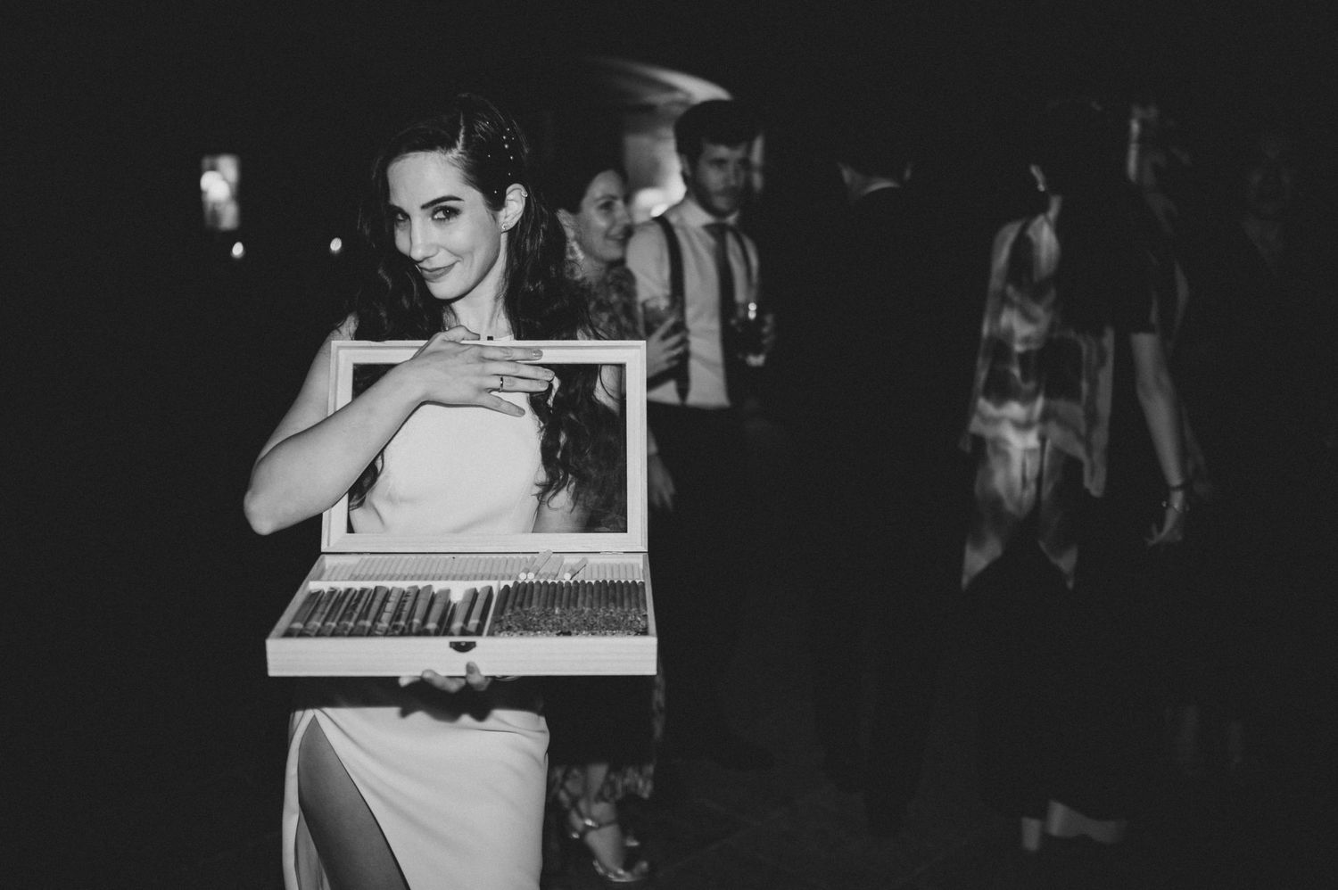 Vintage black and white image of people gathered at what appears to be a social event or party.