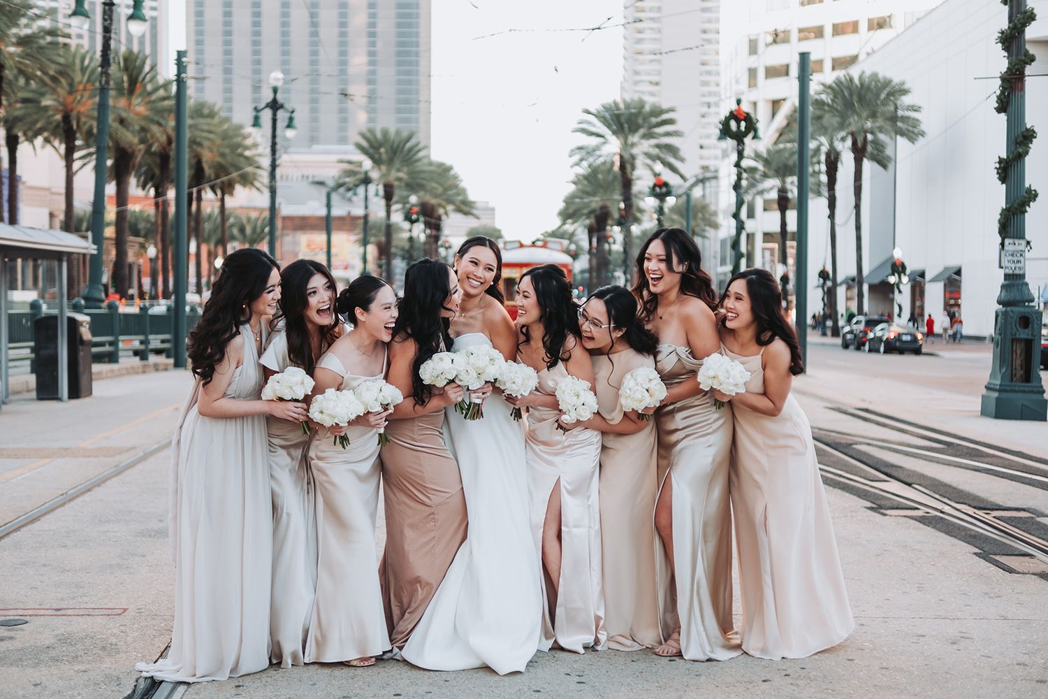 New Orleans wedding party photos with bridal party, bridesmaids, captured on canal street with street car candid and classic group portraits