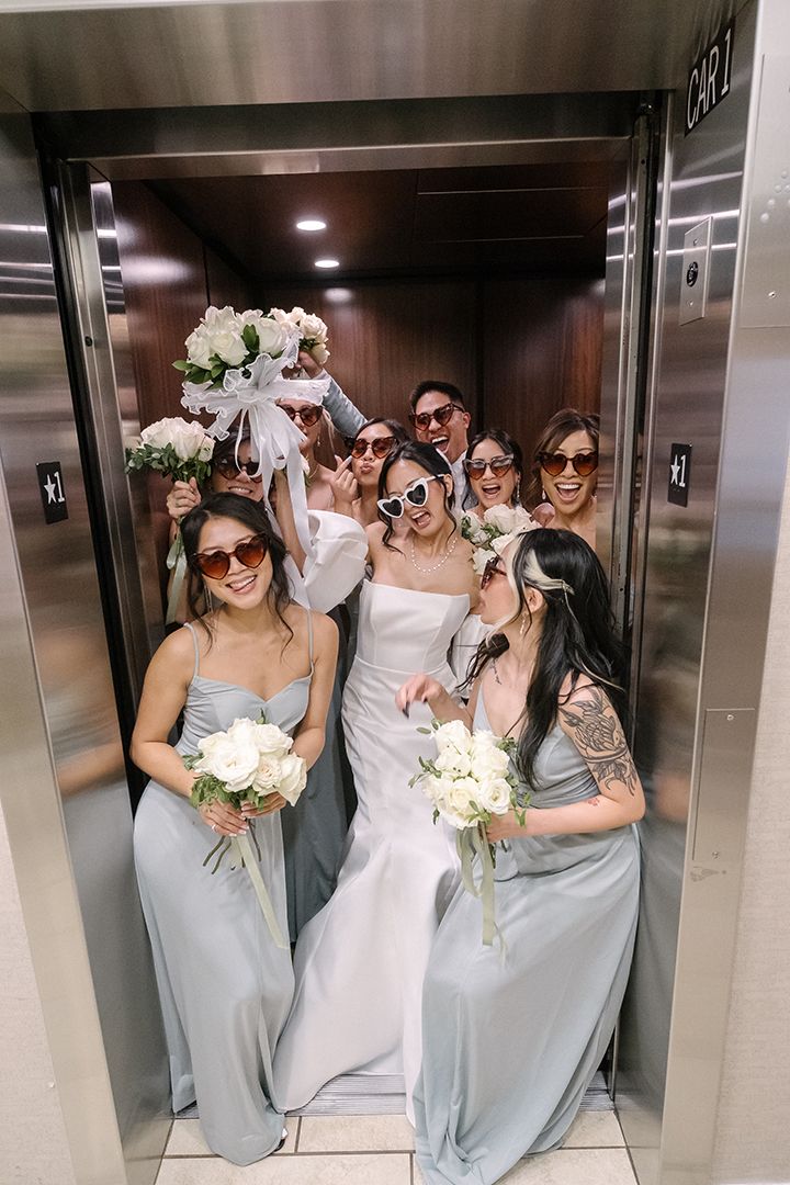 New Orleans wedding party photos with bridal party, bridesmaids, and captured in candid and classic group portraits in elevator
