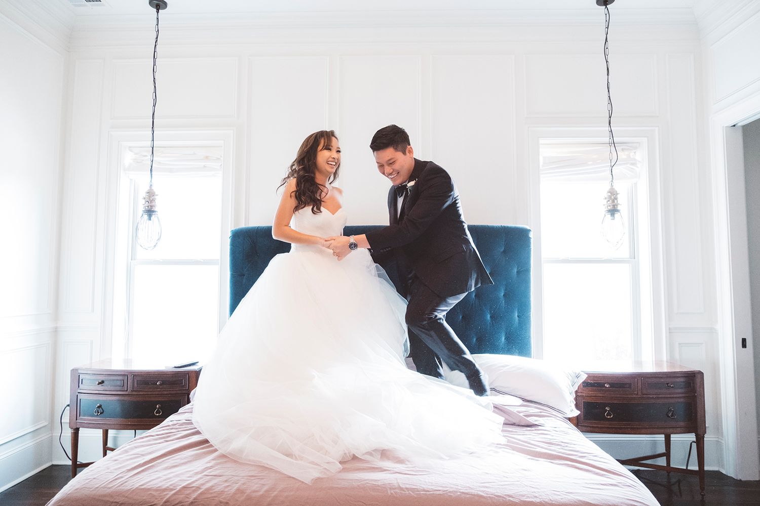New Orleans wedding party photos bride and groom captured in candid and fun jumping on bed