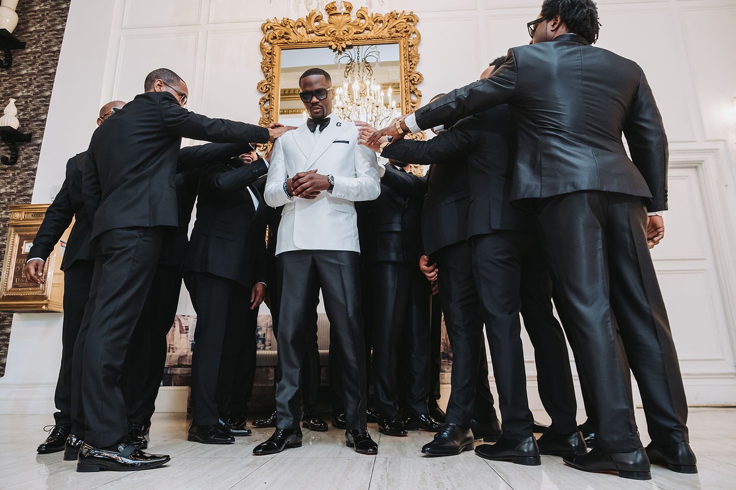 New Orleans wedding party photos groomsmen captured in candid and classic group portraits.  groomsmen praying on groom.  black wedding