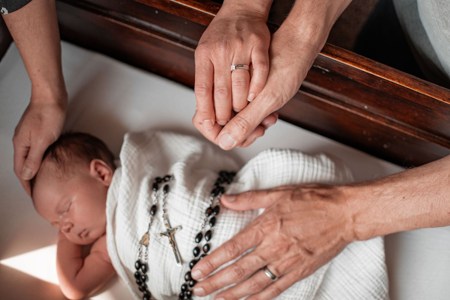 Wausau, Eau Claire, Green Bay, Wisconsin Wedding | Family | Newborn Photography. Newborn in white clothing featuring rosary.