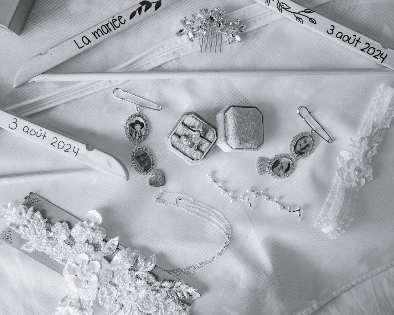 Flat lay of elegant bridal accessories including rings, jewelry, and lace details dated August 3, 2024.
