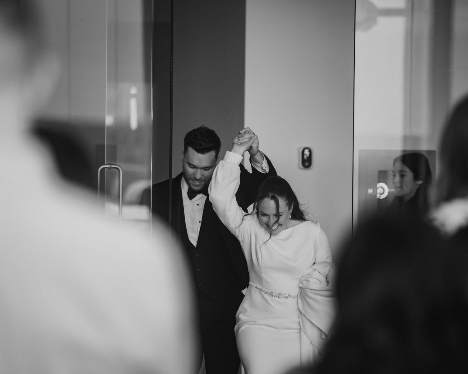 Bride and groom share a romantic dance in black and white wedding photo.