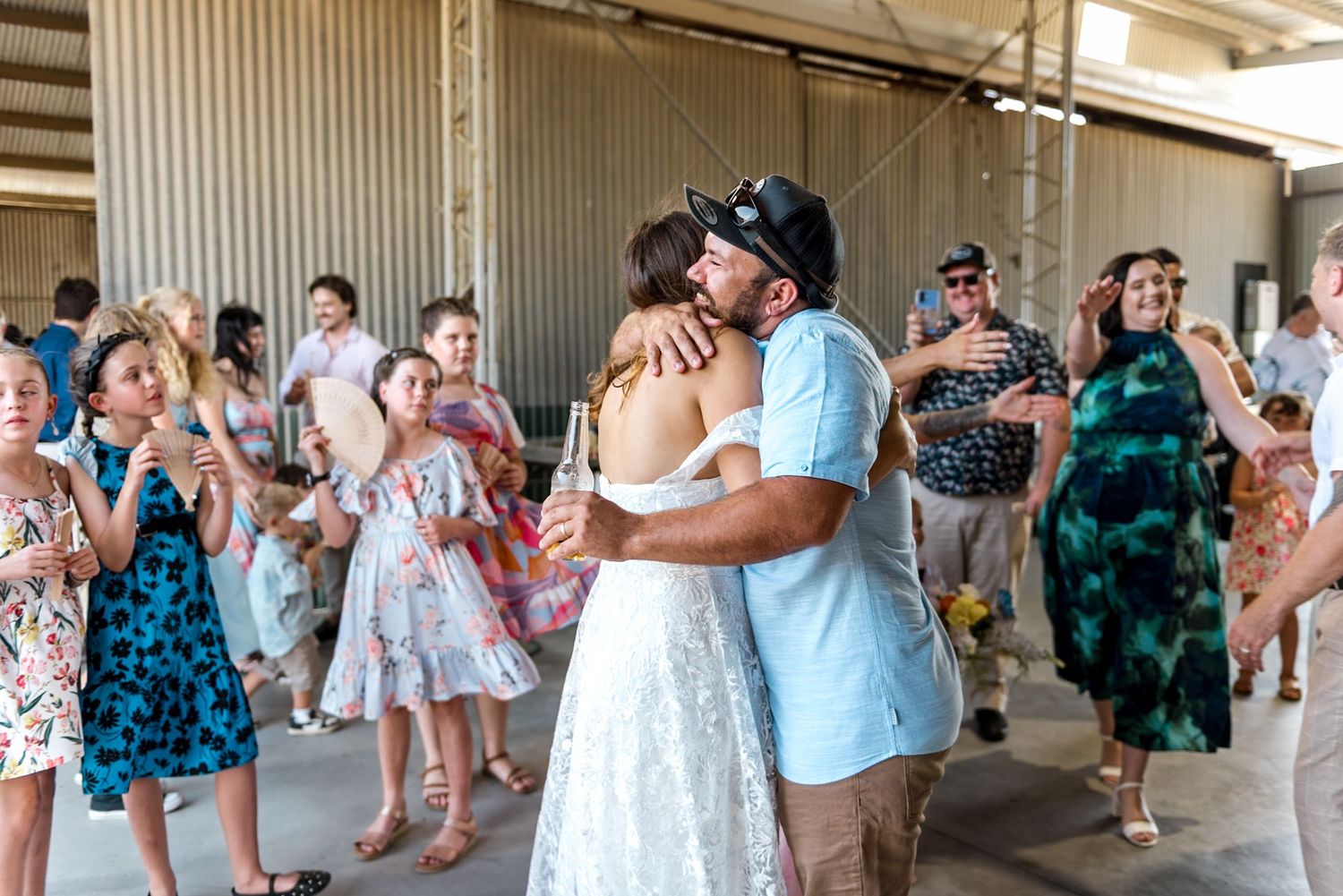 Bride and groom share a heartfelt embrace on the dance floor at barn wedding.