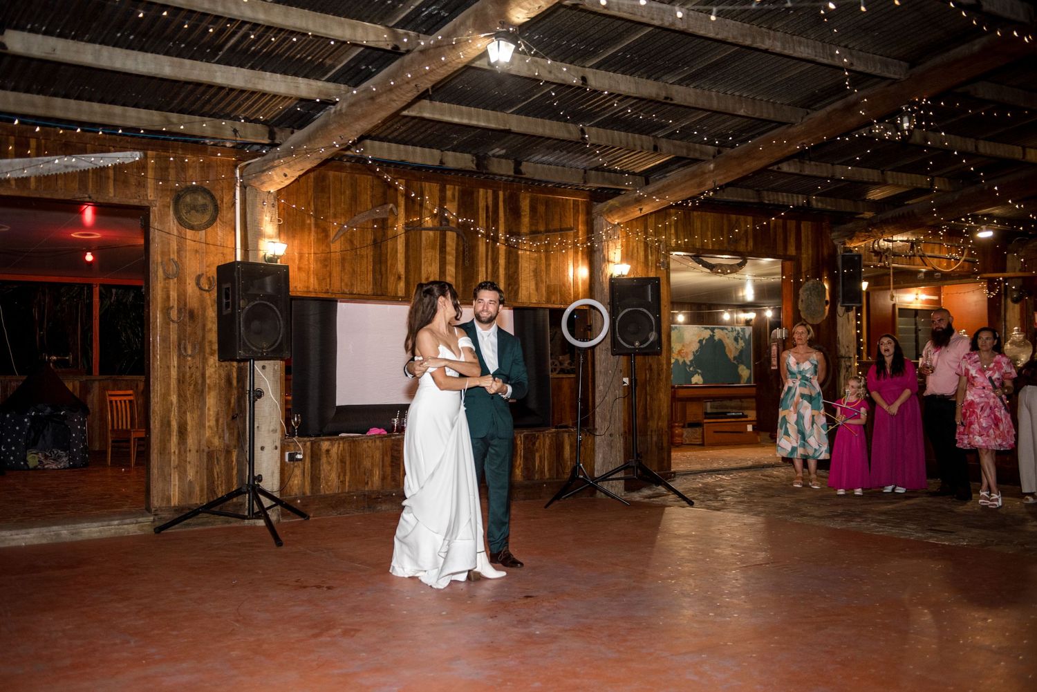 Bride and groom share their first dance in a rustic barn wedding venue.