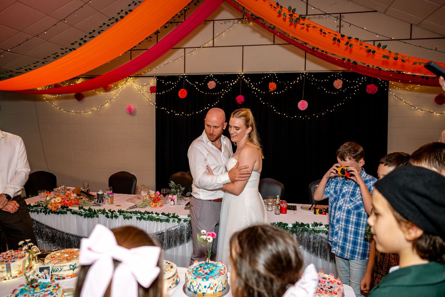 Bride and groom share a romantic dance at their festive wedding reception.