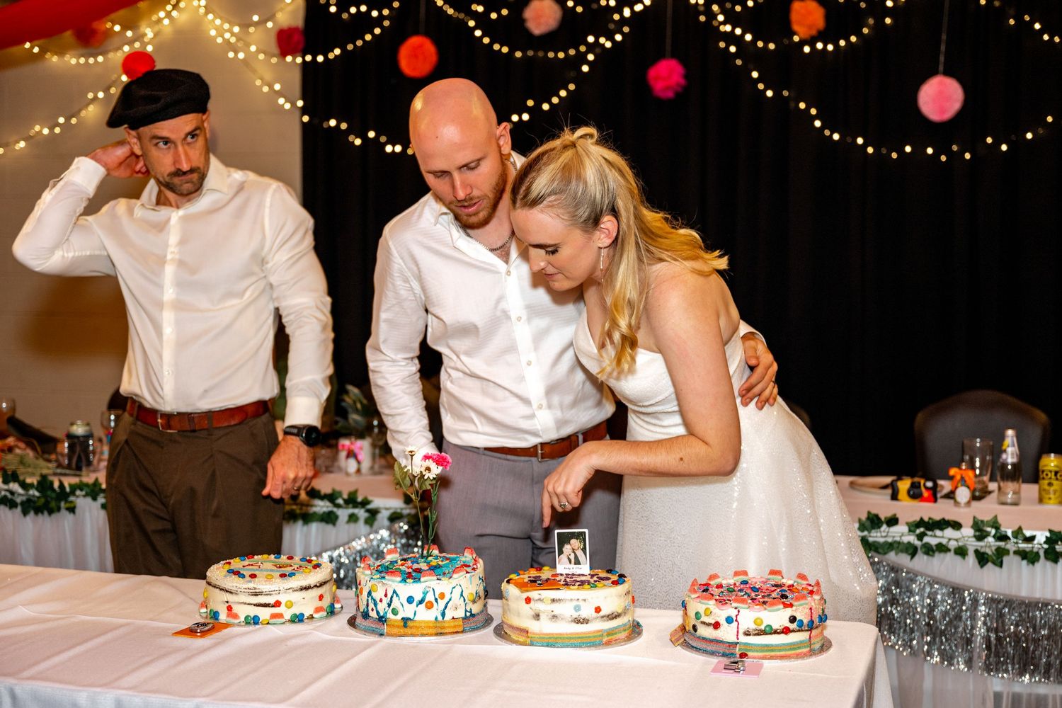 Bride and groom cut their decorated wedding cakes at the reception.