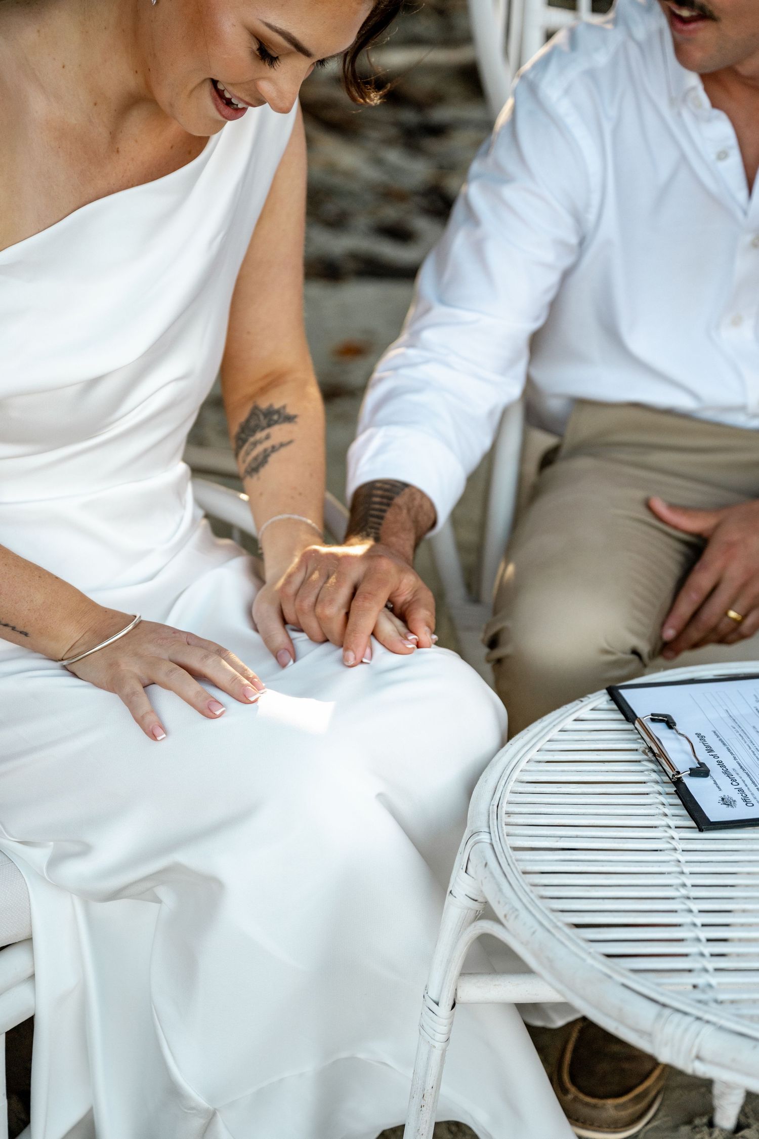 Bride and groom holding hands during an intimate beach wedding ceremony moment at Four Mile Beach, Port Douglas.