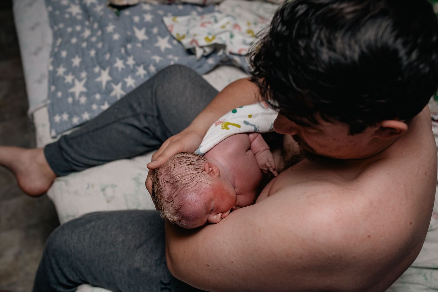 Father and baby bonding through skin to skin, documented by a local raw birth photographer near Portland, Vancouver, supporting home births.