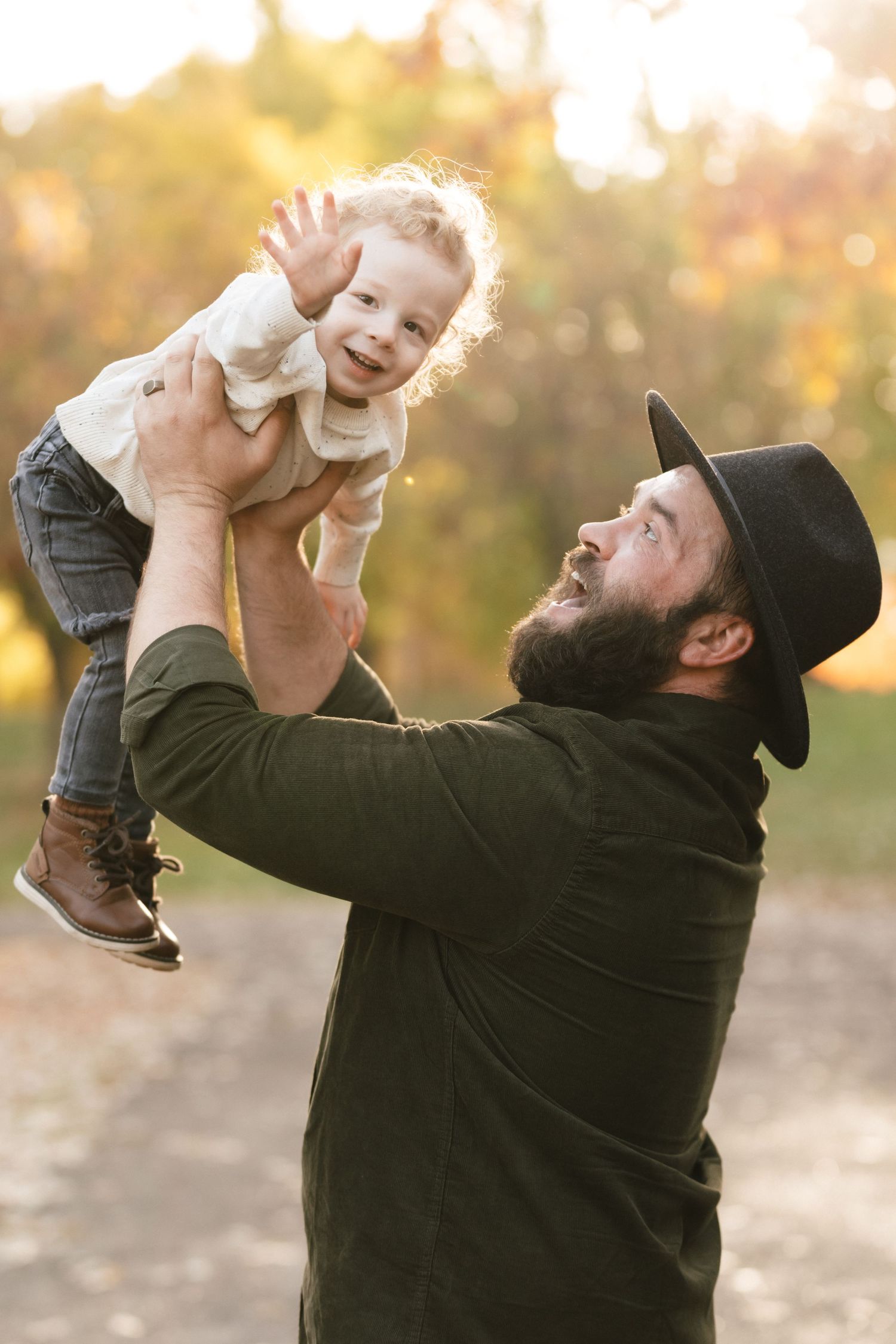 A series of candid photos shows joyful outdoor playtime between a parent and baby against a warm sunlit background.